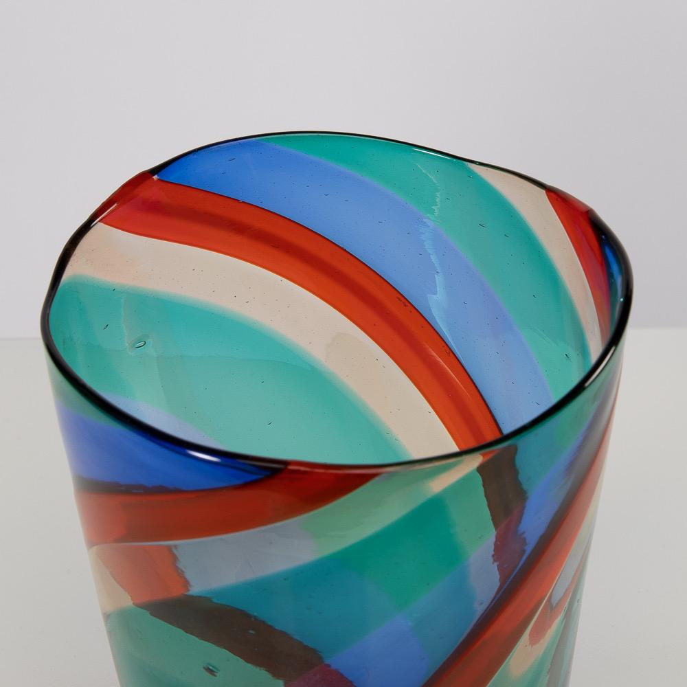 Murano mouth blown glass vase designed by Fulvio Bianconi for Venini in 1951. 
Blown with different colors of twisted bands (Blue, red, green and straw).

This model was presented by Venini at the 9th Milan Triennale in 1951 and is considered as