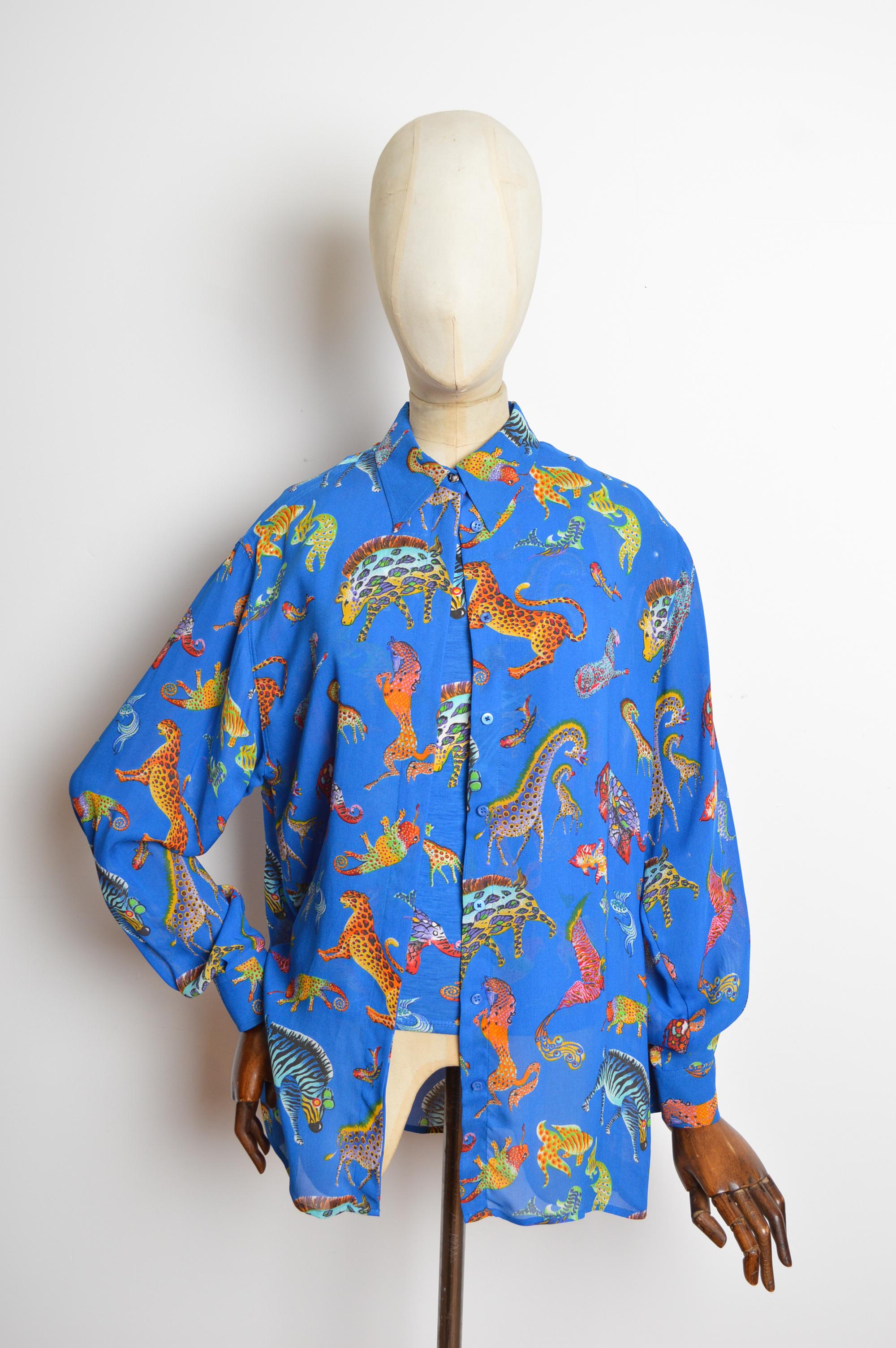 Ein wunderbares Gianni Versace Jeans Couture Ensemble aus den 1990er Jahren. Bestehend aus einem halbtransparenten Langarmshirt und einem dazu passenden, eng anliegenden Tank-Top. Es ist aus einem äußerst lebendigen und farbenfrohen blauen Stoff