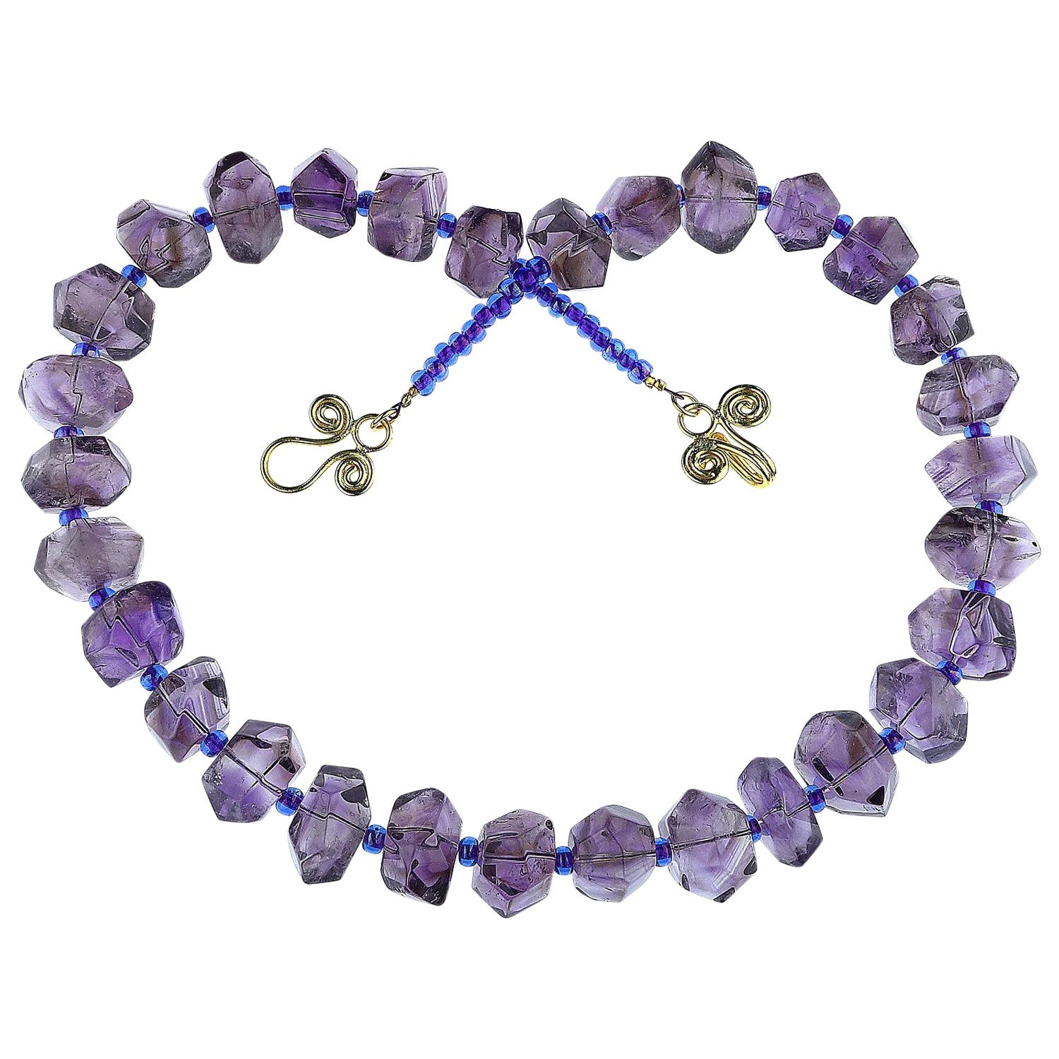 Highly polished chunks of medium tone Amethyst accented with sparkling Czech purple beads necklace. This necklace is finished with a scrolly 18K gold plated clasp. It is fun and funky. This Amethyst necklace, the February birthstone, will enhance