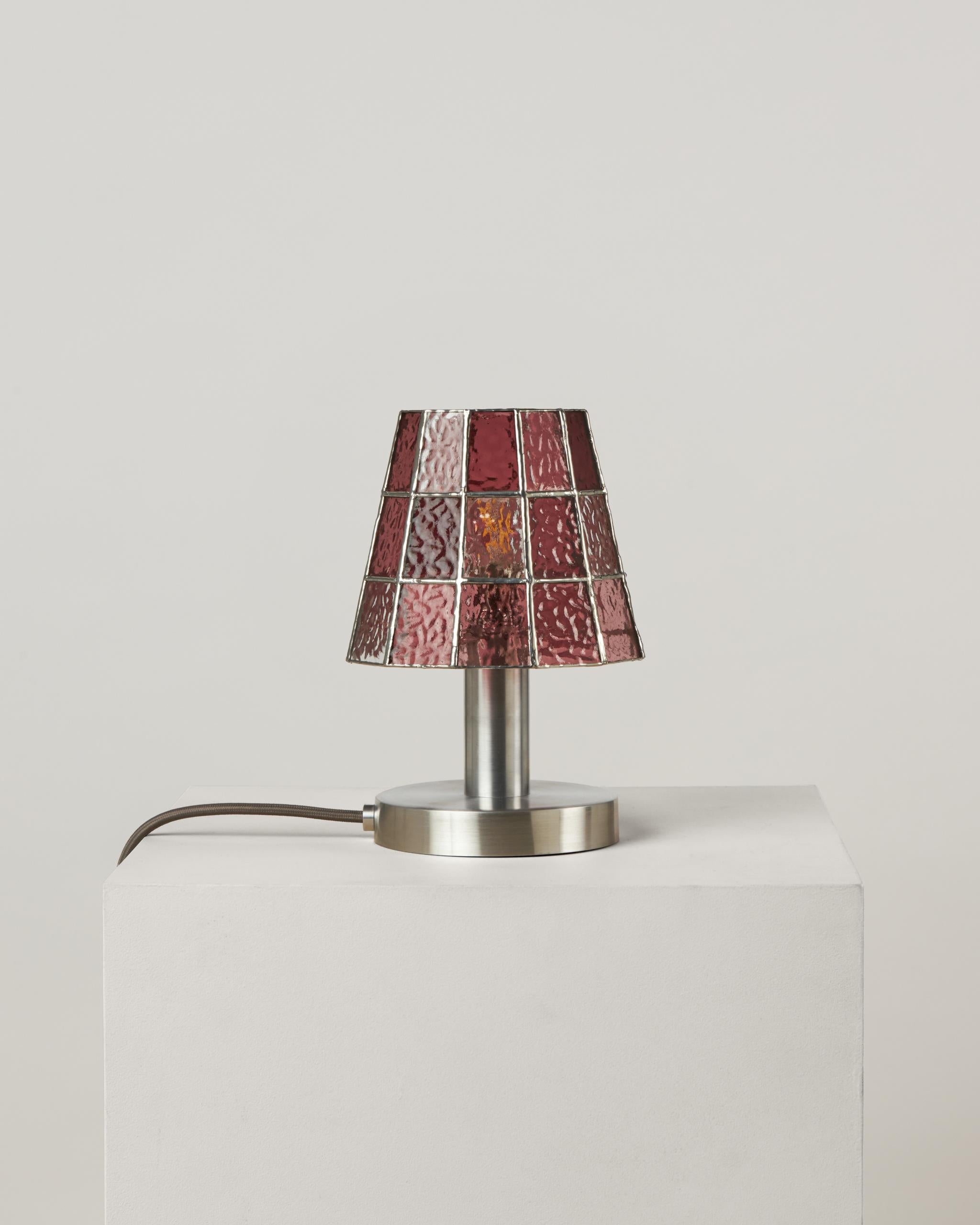 The Fun Guy table lamp is equal parts whimsy and grace. 

Drawing on the forms and luminescent coloring of wild mushrooms and fungi, a chunky aluminum base is capped with a handmade stained glass shade that surprises and delights with an ever