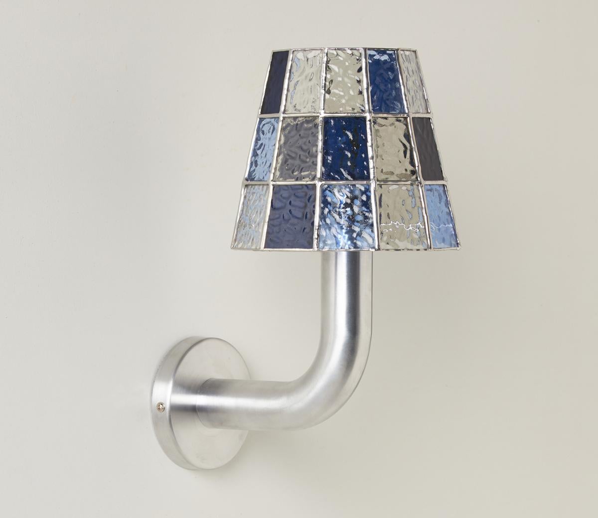 The Fun Guy Wall Light is equal parts whimsy and grace. 

Inspired by the forms and luminescent coloring of wild mushrooms and fungi, a chunky aluminum base is capped with a handmade stained glass shade that provides an ever changing interplay of