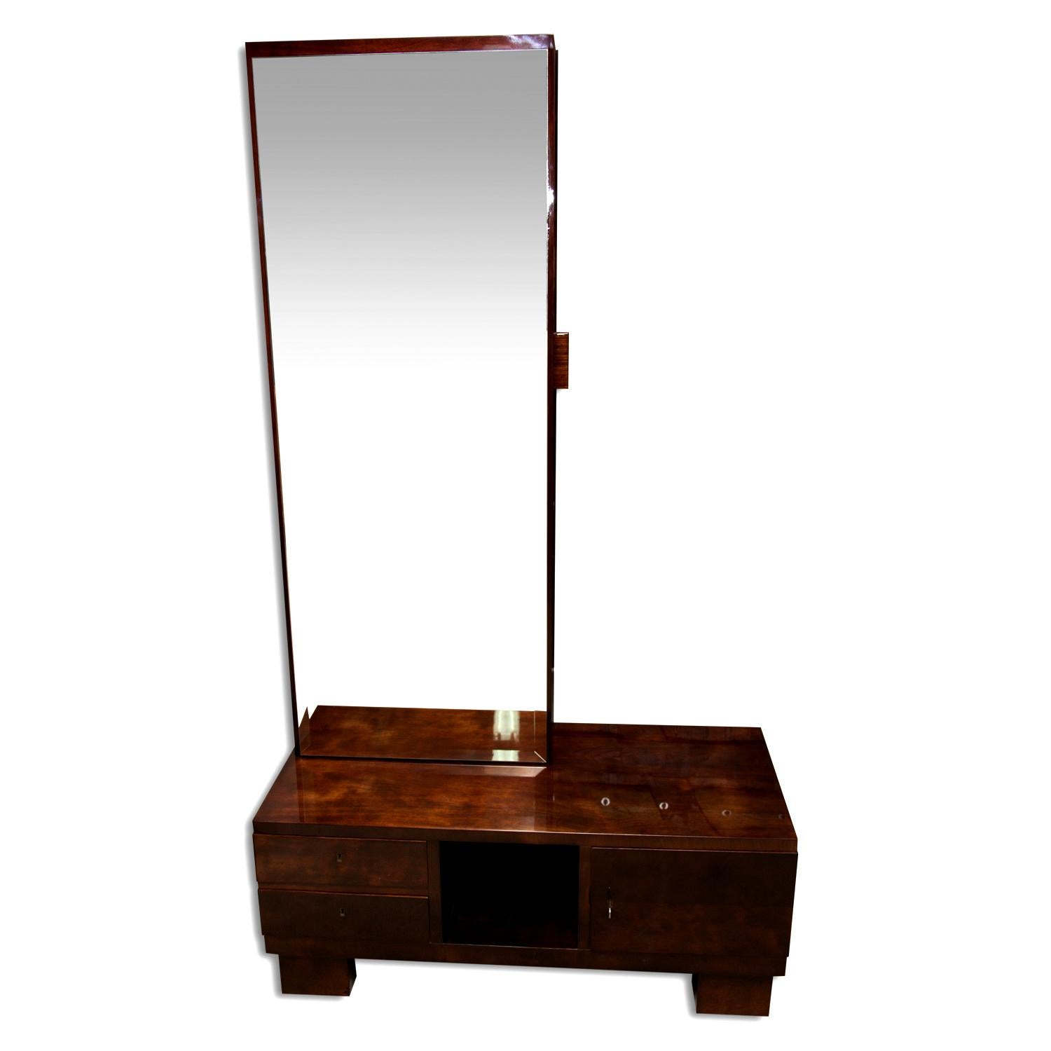 Luxurious functionalist vanity or dressing table-mirror with a drawer for toiletries on the side. It was made of solid wood with walnut veneer. The mirror is equipped with a storage space at the bottom. Very interesting design. It was made in the