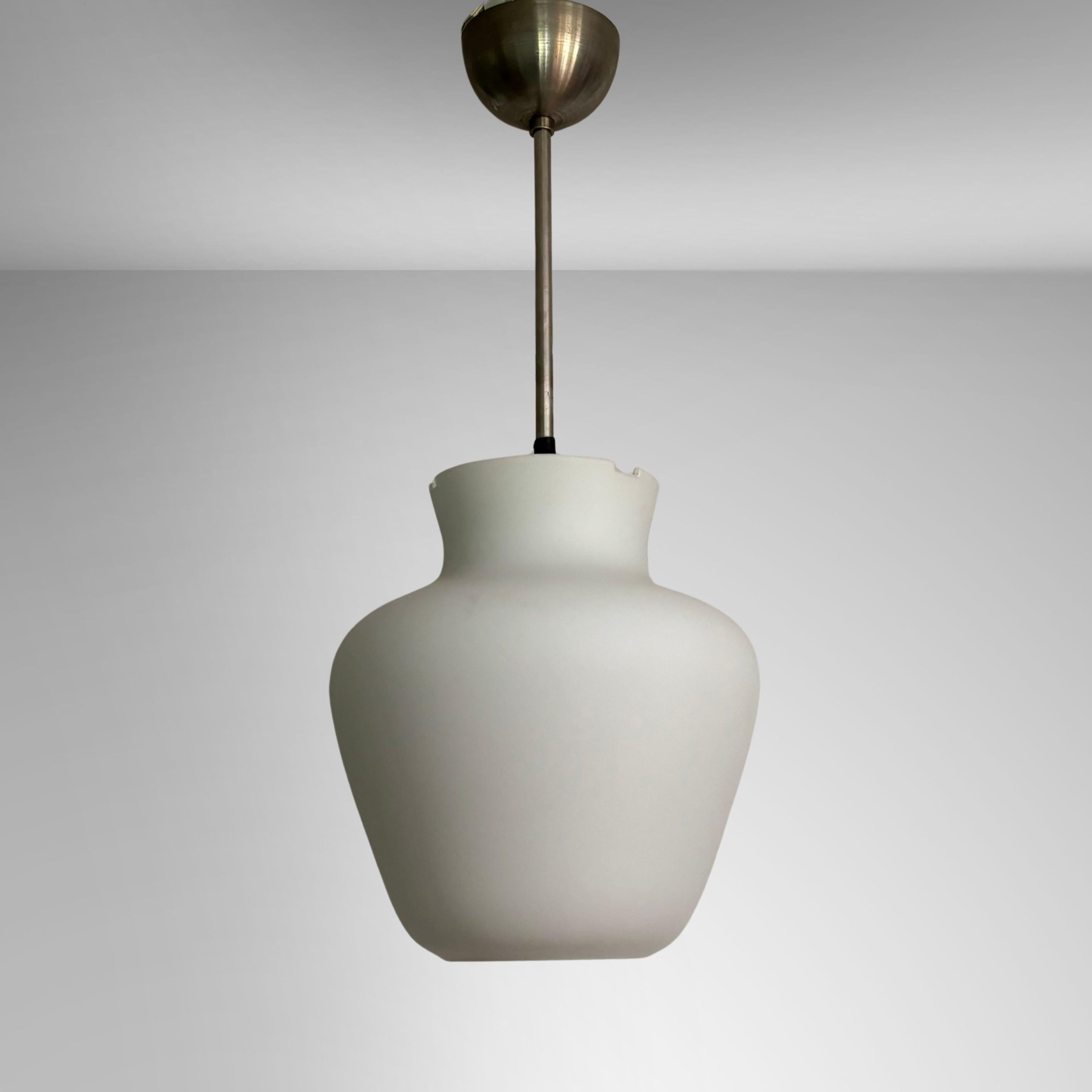 A functionalist pendant light fixture produced by the Swedish manufacturer ASEA in the 1940s, attributed to the architect Gunnar Asplund. The softly shaped shade is crafted from opal glass and is held in place by a chrome metal fixture.

ASEA, the