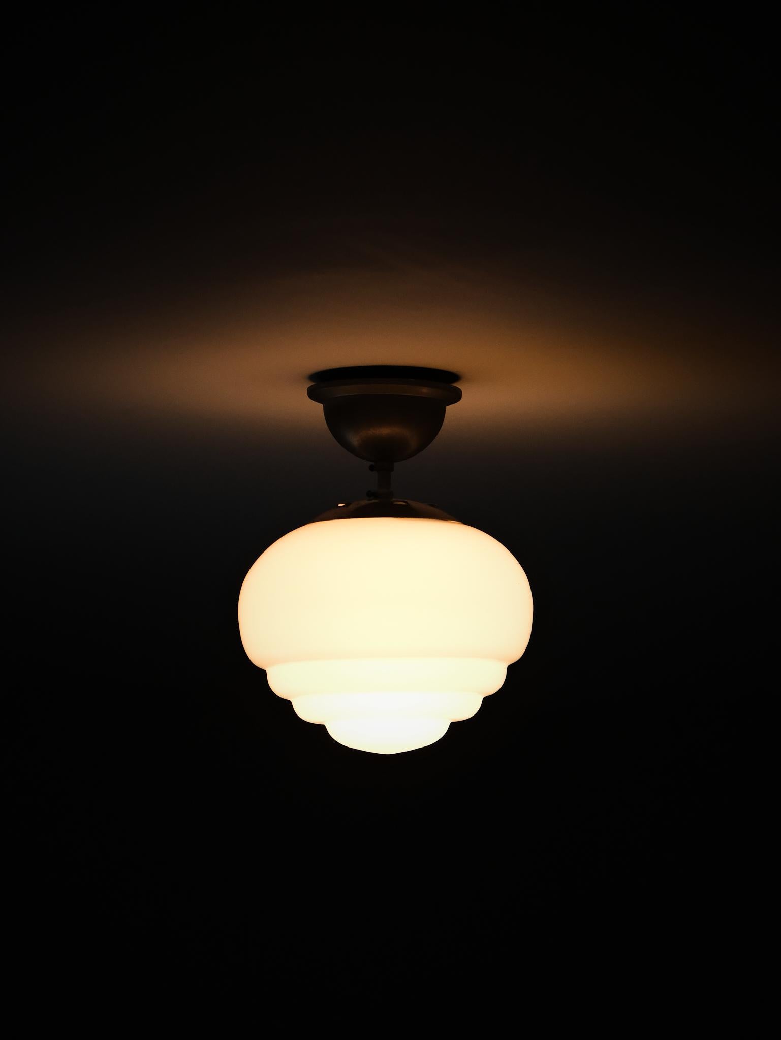 Elegant ceiling lamp in classic Swedish functionalist design, made by unknown designer during the 1930s.

Made with opaline glass and nickel fittings, showcasing a timeless balance of simplicity and refinement.