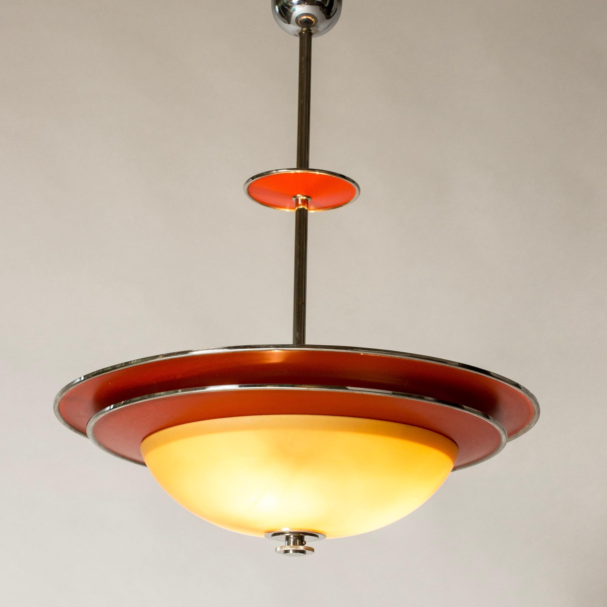 Amazing functionalist ceiling light by Erik Tidstrand, made from coral red lacquered metal, chrome details and a yellow tinted glass shade. Graphic silhouette.