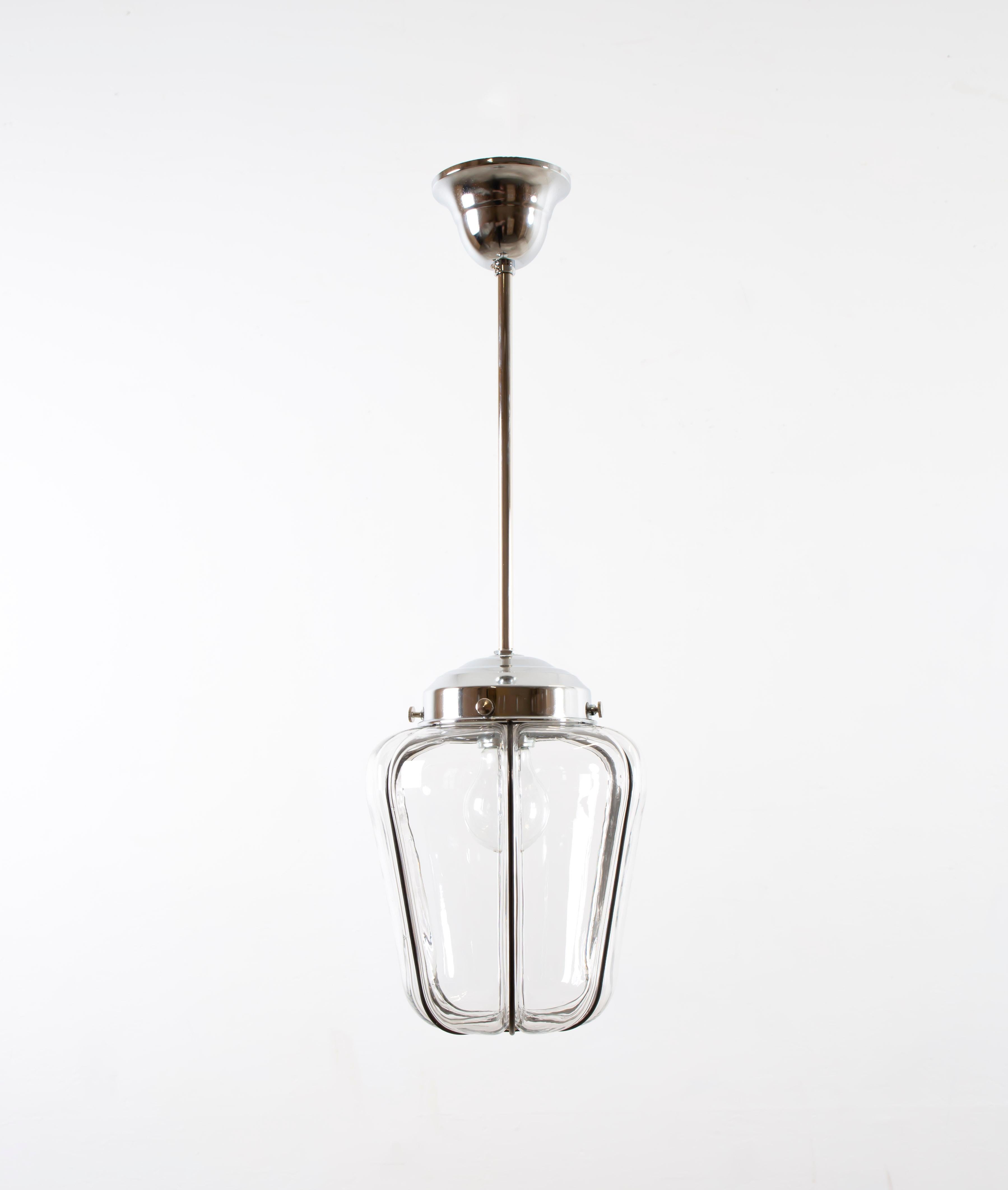 Decorative ceiling light with a clear glass shade on a steel wire frame and chrome stem. Most likely designed and made in Norway from circa first half of the 1950s. The lamp is fully working and in very good vintage condition. It is fitted with one