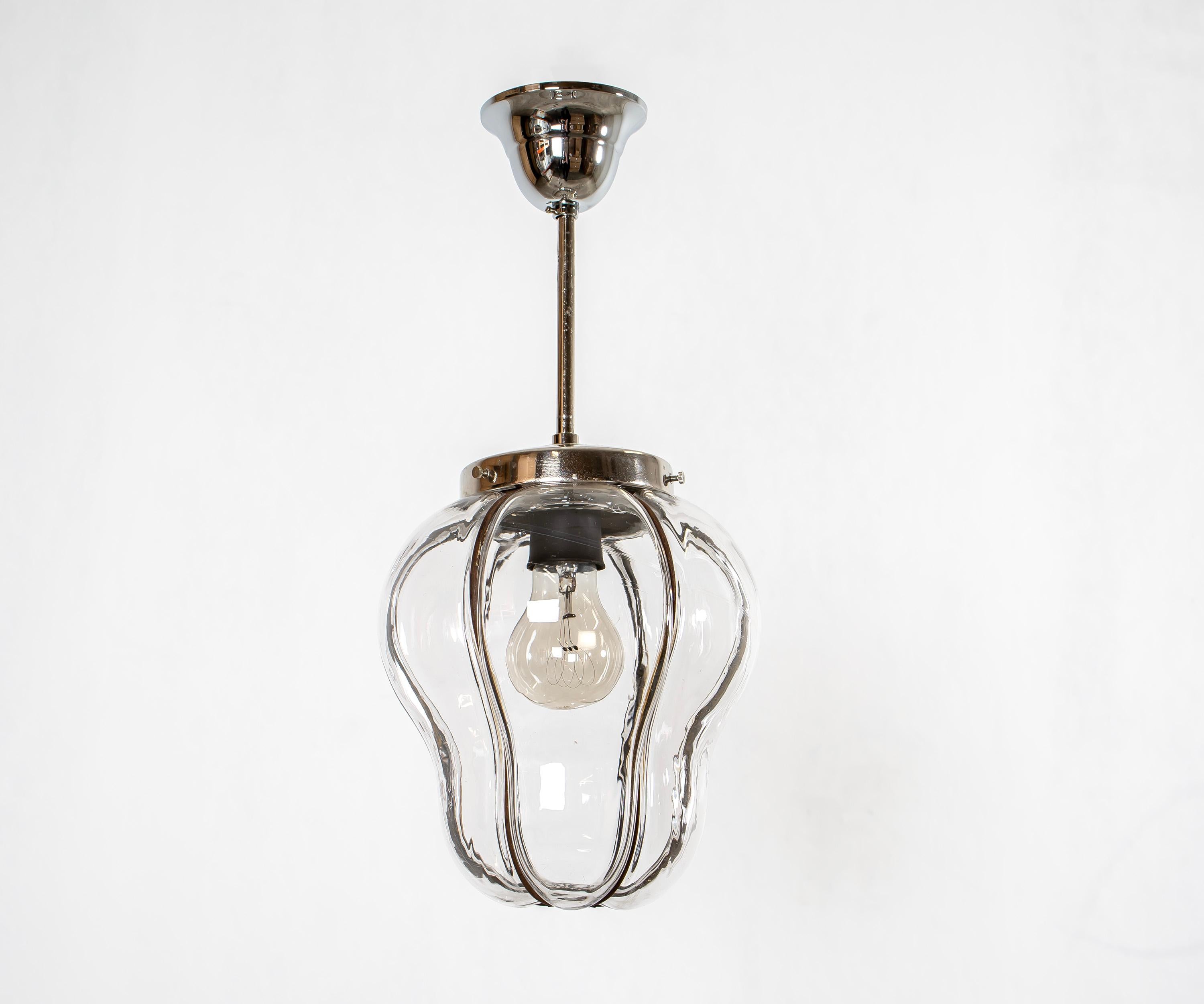 Decorative ceiling light with a clear glass shade on a steel wire frame and chrome stem. Designed and made in Norway from circa 1950s first half. The lamp is fully working and in very good vintage condition. It is fitted with one E27 bulb holder