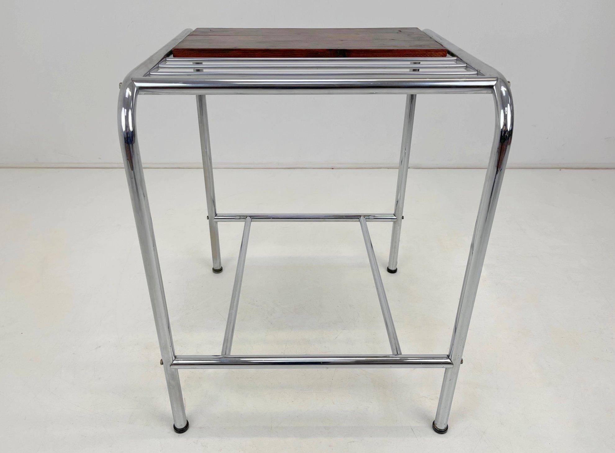 Functionalist or Bauhaus chrome side table with wooden shelf. 
Good original condition.