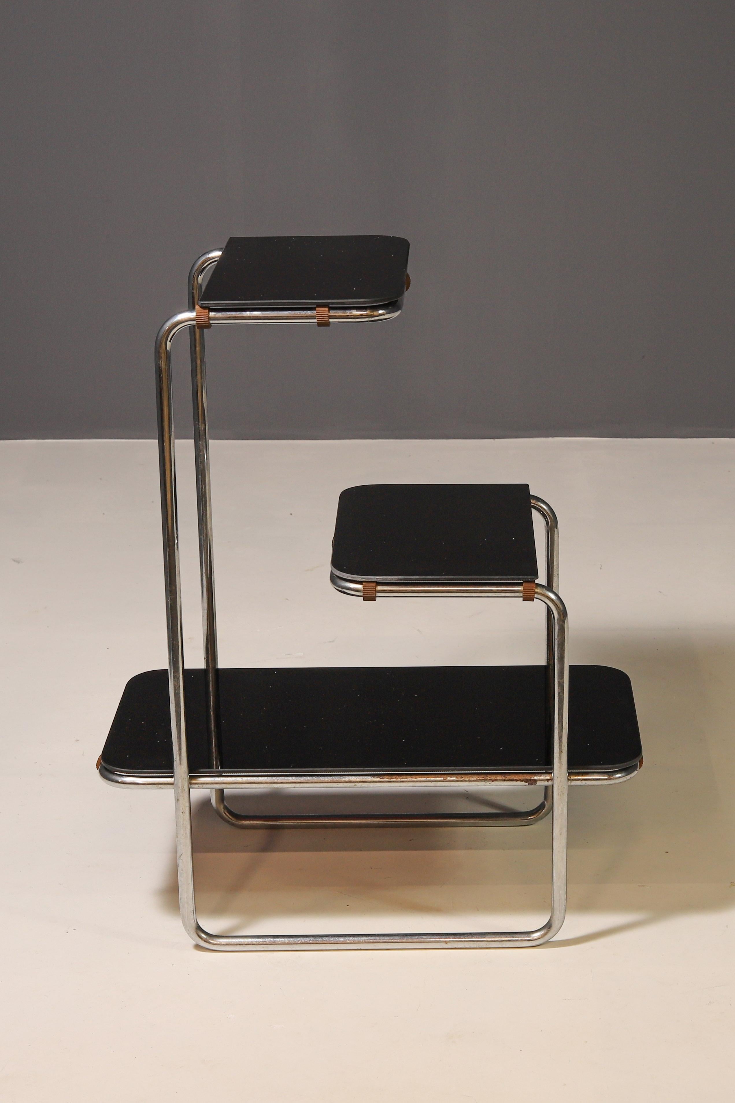 This elegant functionalist étagère was originally designed by Anton Lorenz and produced in the 1930s–1940s by the renowned manufacturer Robert Slezák, later known as the national company Kovona. It is a stunning piece of furniture that perfectly