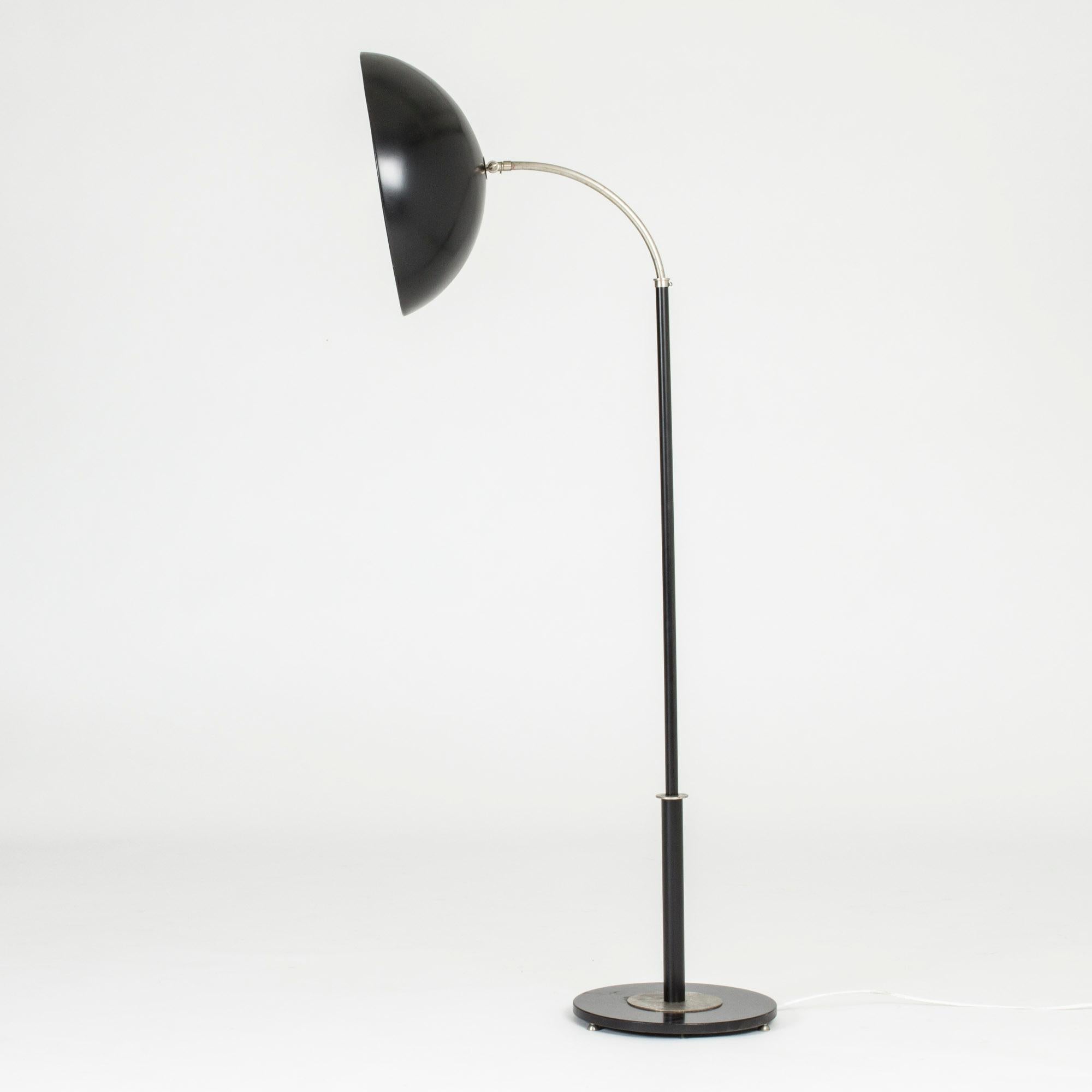 Striking functionalist floor lamp by Bo Notini, made from steel with a black lacquered shade and base.