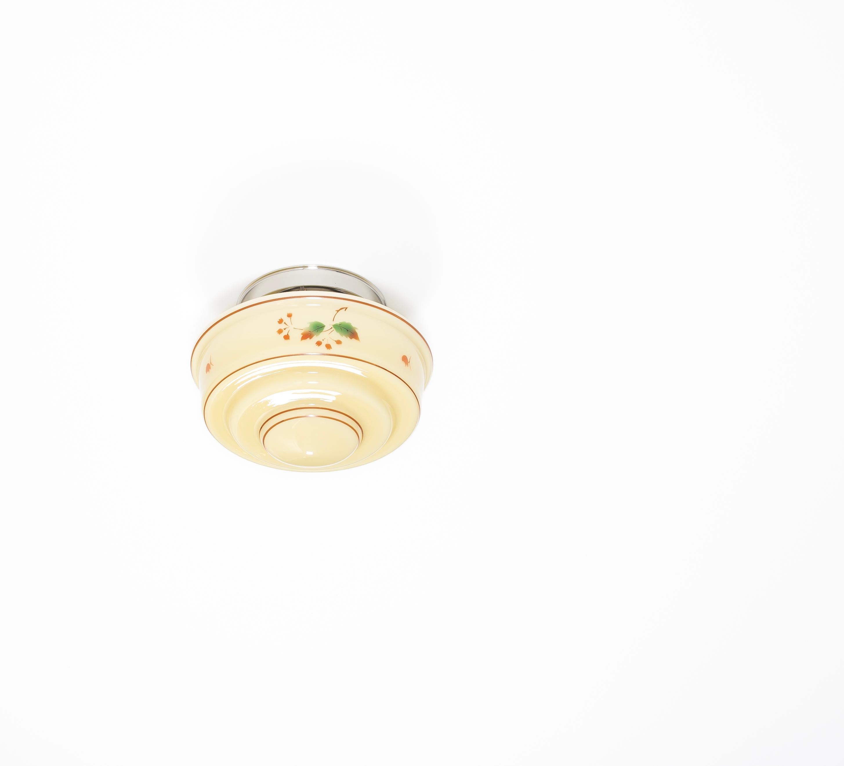 Wonderful and decorative ceiling light with hand-painted shade in opaline glass and chrome metal base. Designed and made in Norway from ca 1950s first half. The lamp is fully working and in good vintage condition. It is fitted with one E27 bulb