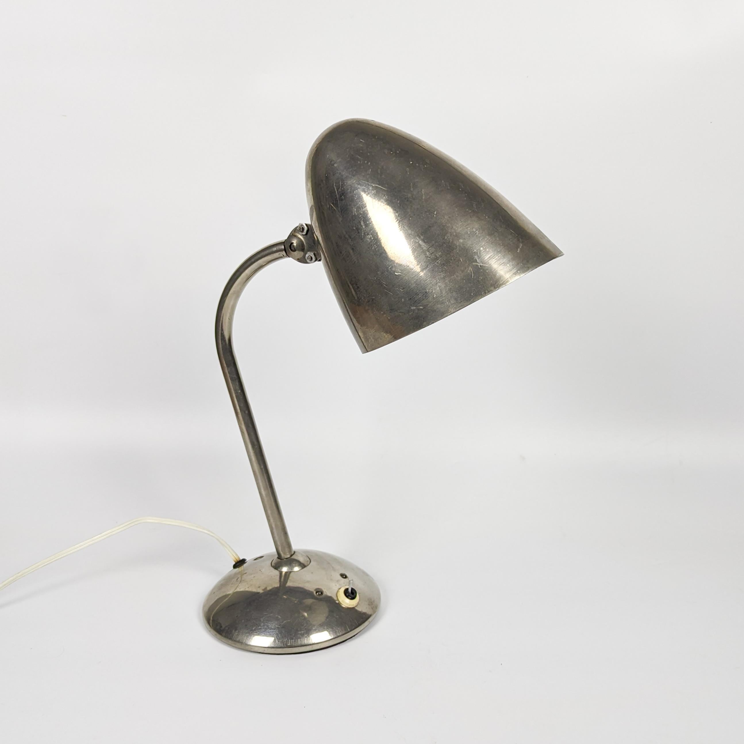 Iconic table lamp produced by the Franta Anýž Company and designed by Jaroslav Anýž, his son in early 1930s. This desk lamp is renowned for its distinctive joints, patented to allow the lampshade to pivot in any direction, with adjustable height.