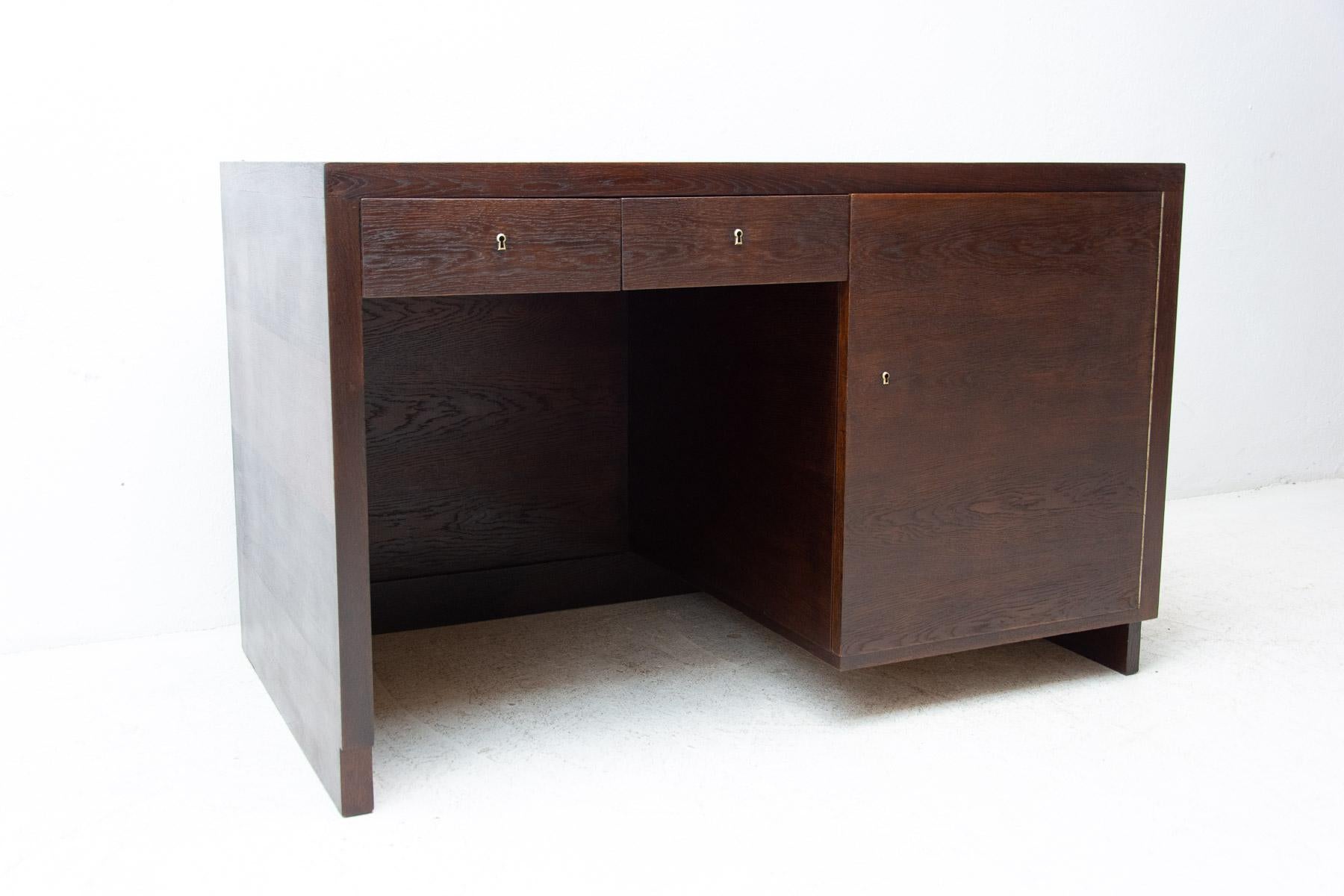 This massive functionalistic writing desk was made in the 1930s in Bohemia. It is veneered with oak veneer. Very interesting design typical for the functionalist period of the 1930s. The table is in very good condition, fully renovated.

Measures: