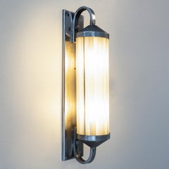 Functionalist style wall light in steel and glass