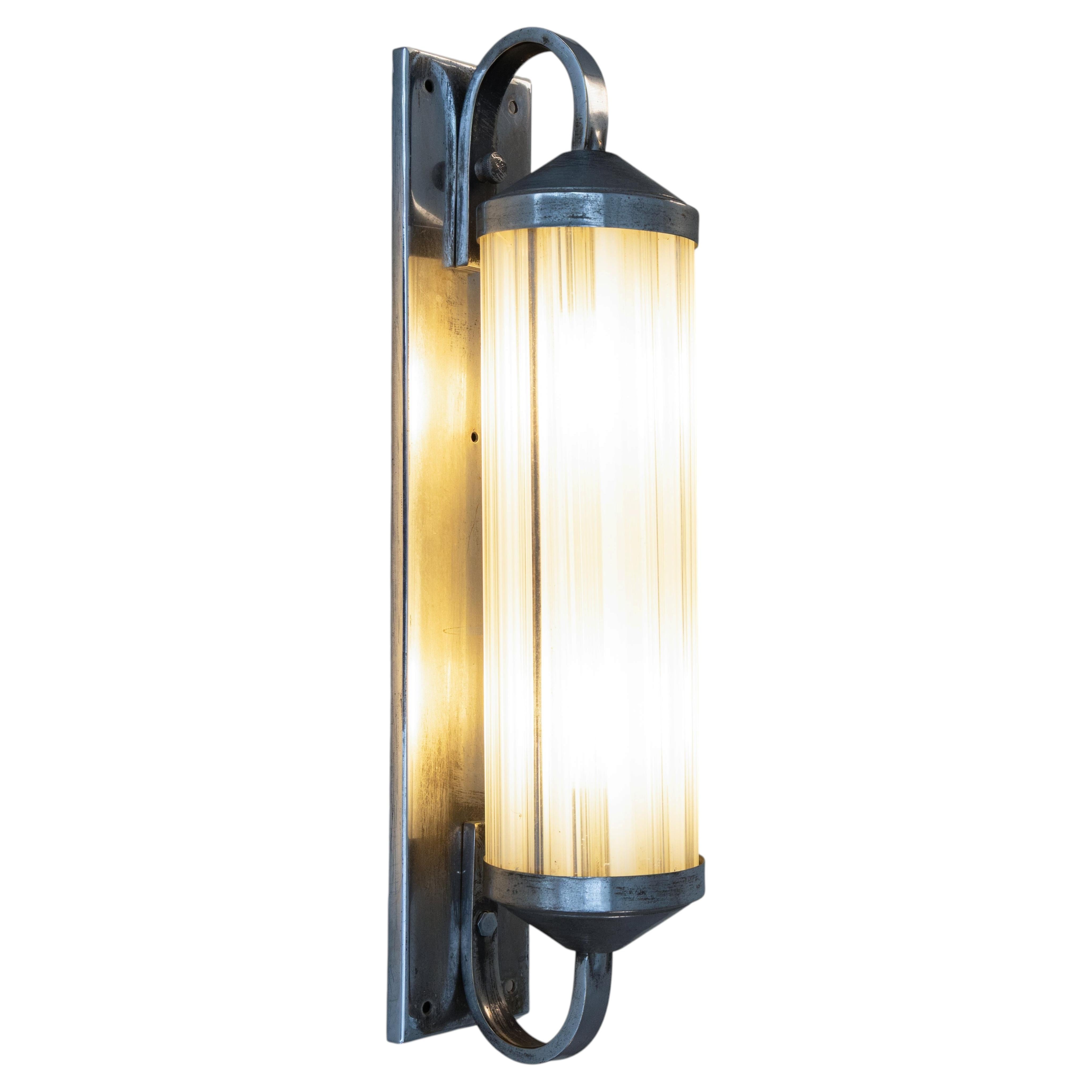 Functionalist style wall light in steel and glass