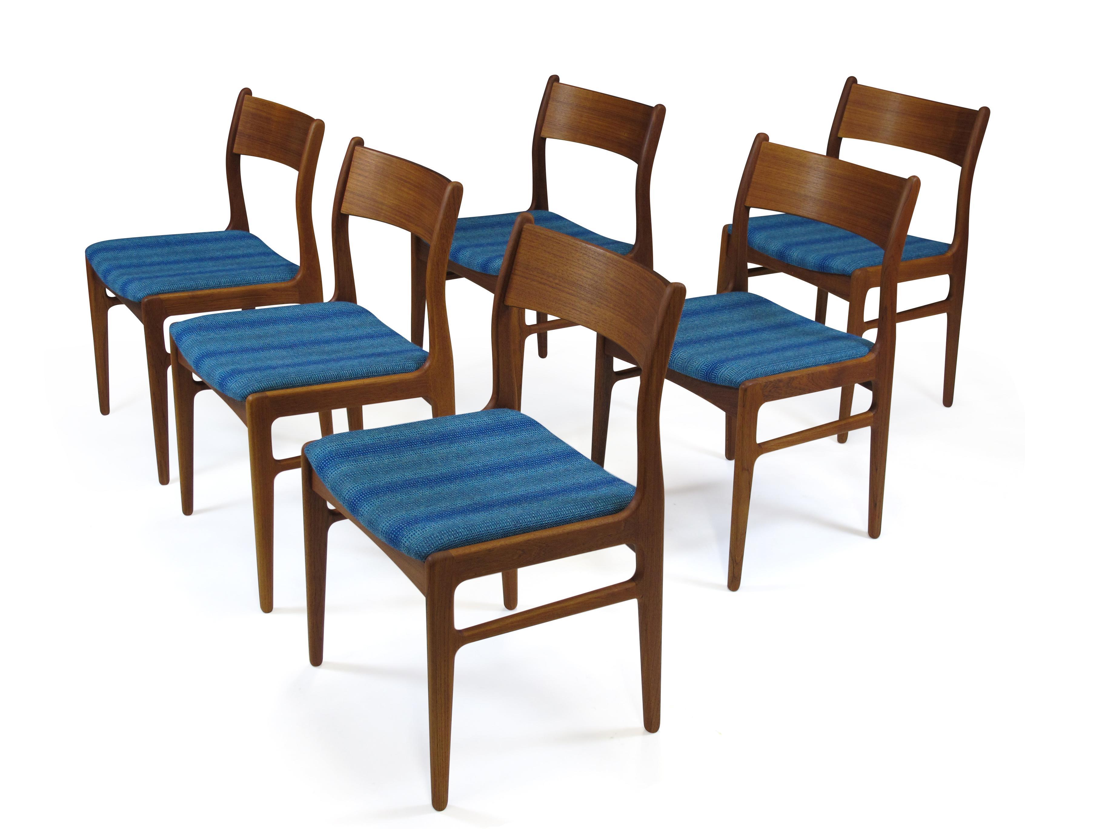 Six midcentury teak dining chairs designed by Funder-Schmidt & Madsen, Denmark. Teak frames with sculpted cross stretchers and a slight curved back for comfort. The chairs have been finely restored and upholstered in blue wool textile. Excellent