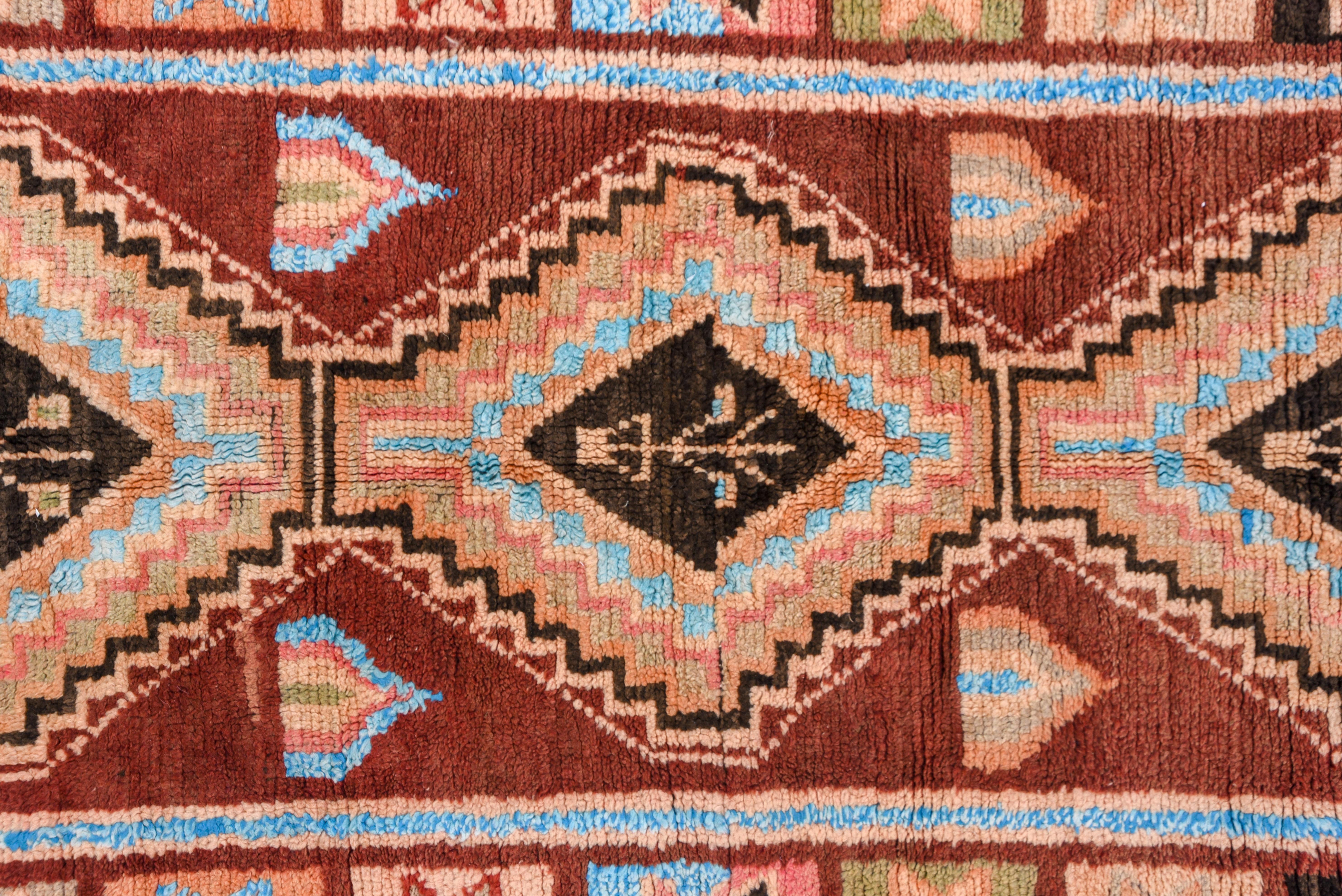 With Caucasian influence, the sienna field features a pole of three tall, stepped octagons and straw tabbed boxes. The border of stars-in-squares has a Turkish flavor. Colorful and makes a statement.