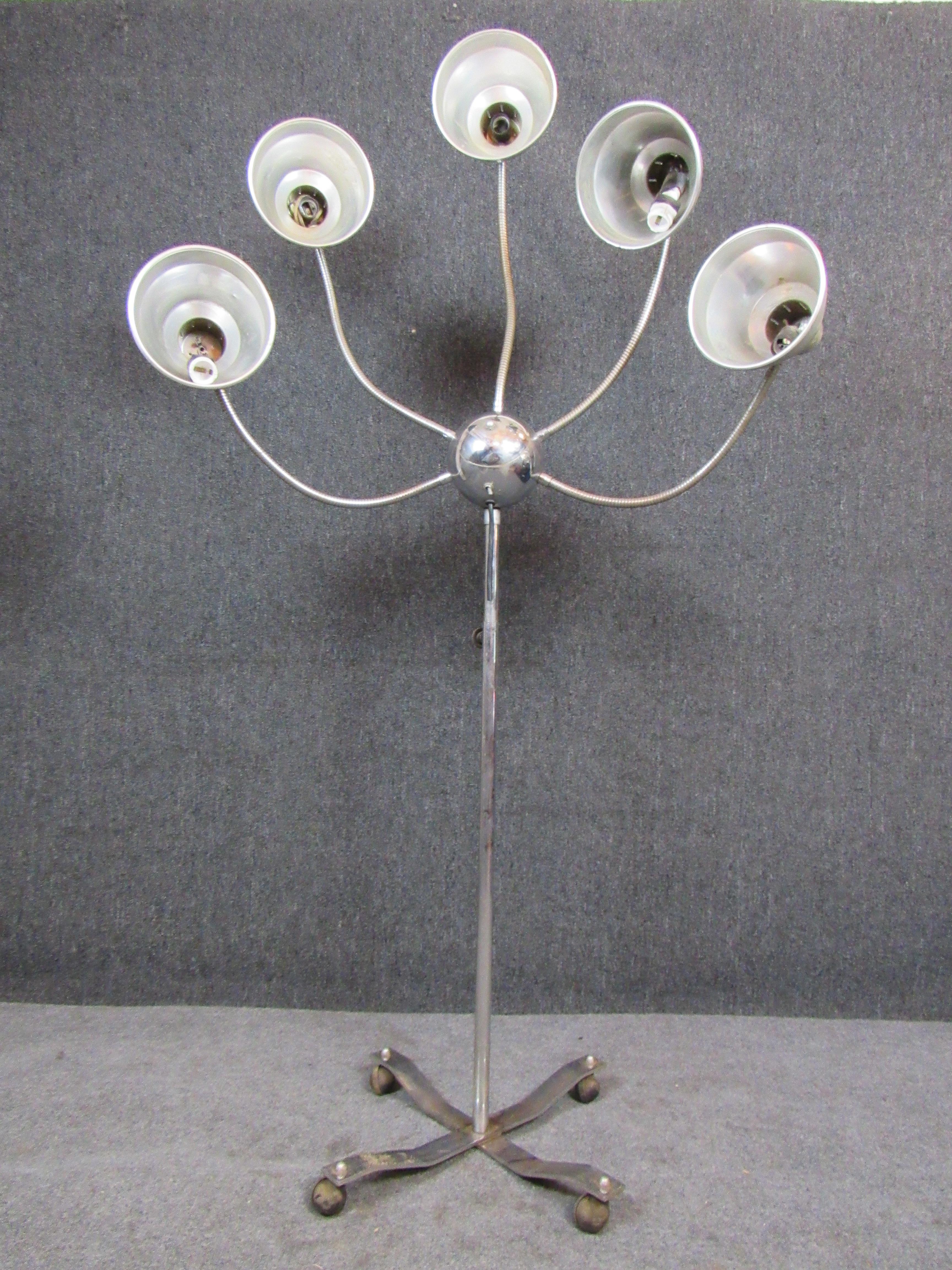 Bring home a floor lamp that is truly out of this world! Sporting five individual lamp shades, each affixed to their own tentacle-like articulated gooseneck sprouting from a chrome central globe, this floor lamp is almost fully alien in appearance!
