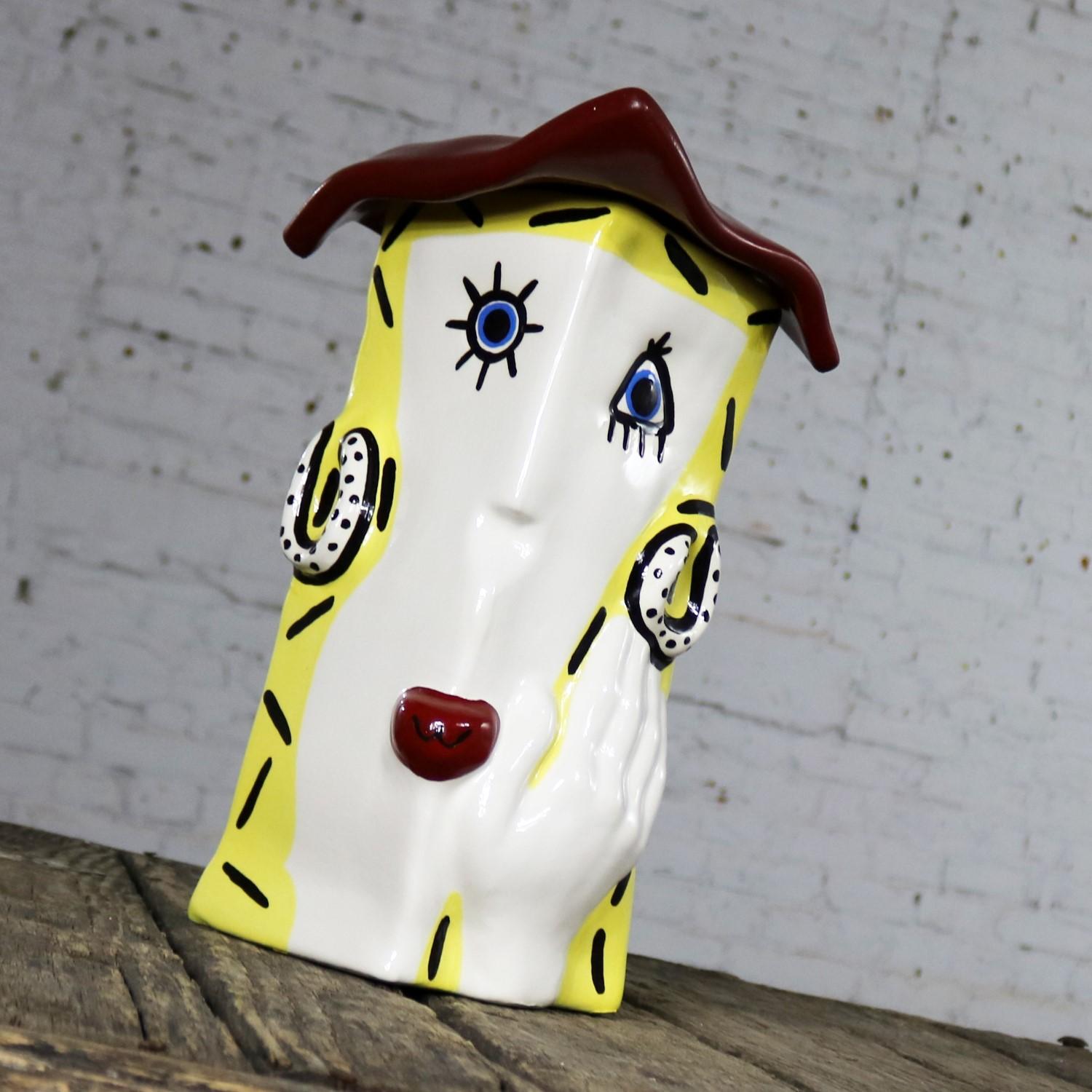 Fun and funky ceramic cookie jar or storage jar in the form of a lady’s head with her hand to her face wearing a red hat. It is in excellent condition with no chips, cracks, or chiggers, circa 21st century.

This unique jar just makes me smile!!!