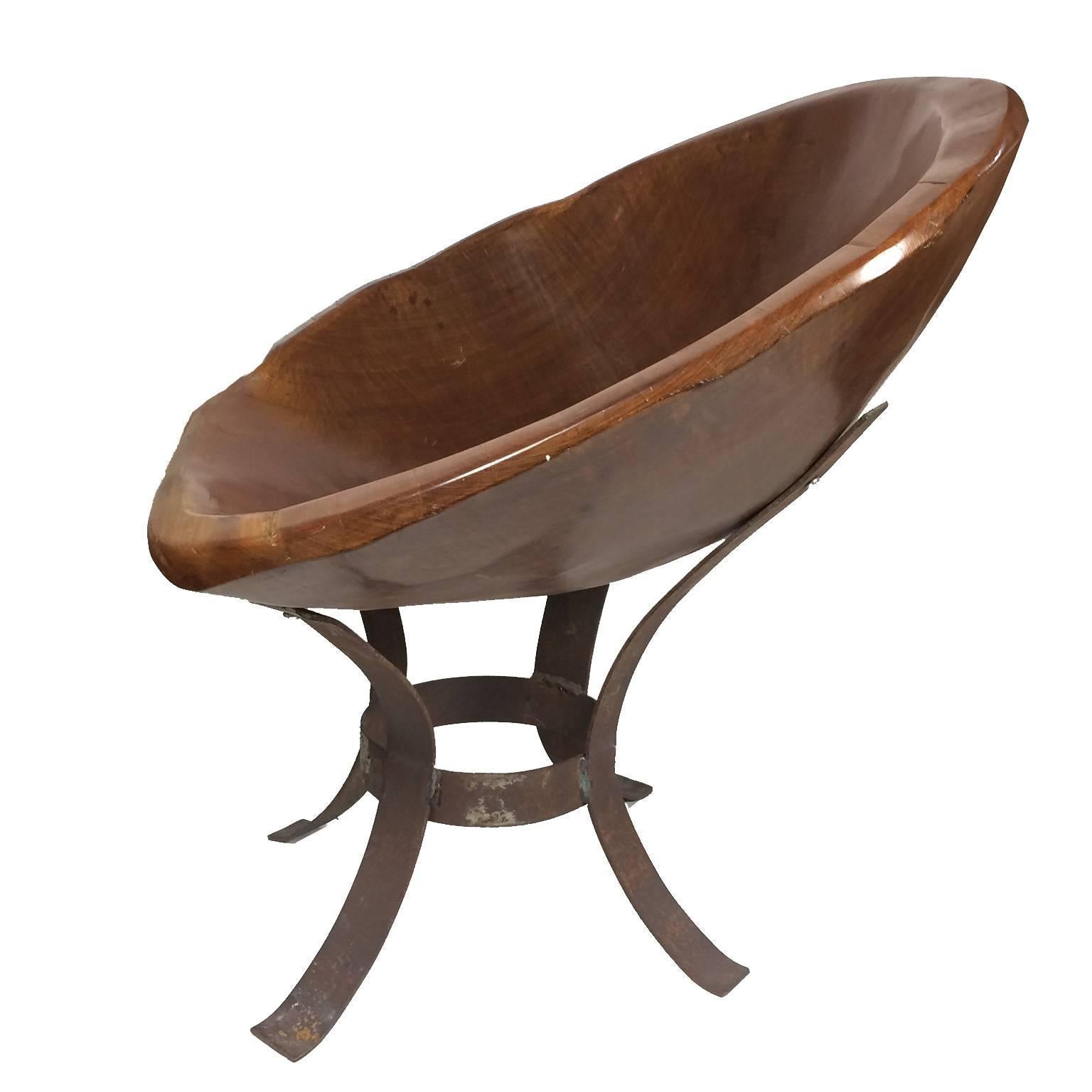 Funky Mid-Century Modern carved hardwood chair, raised on an iron banded base. Measure: Seat height 17 inches, height 28 inches, diameter 29 inches. Quite comfortable.
