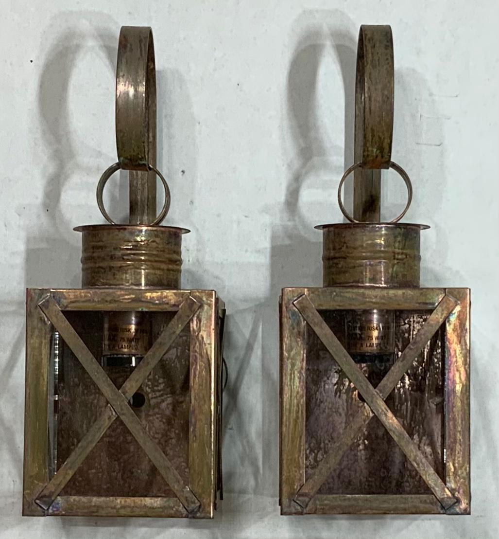 Pair of wall lantern made of solid copper, protective X bars, weathered patina, with one 75/watt light each. Suitable for wet locations. UL approved, up to US code, ready to use.
Fine quality, made in the USA.