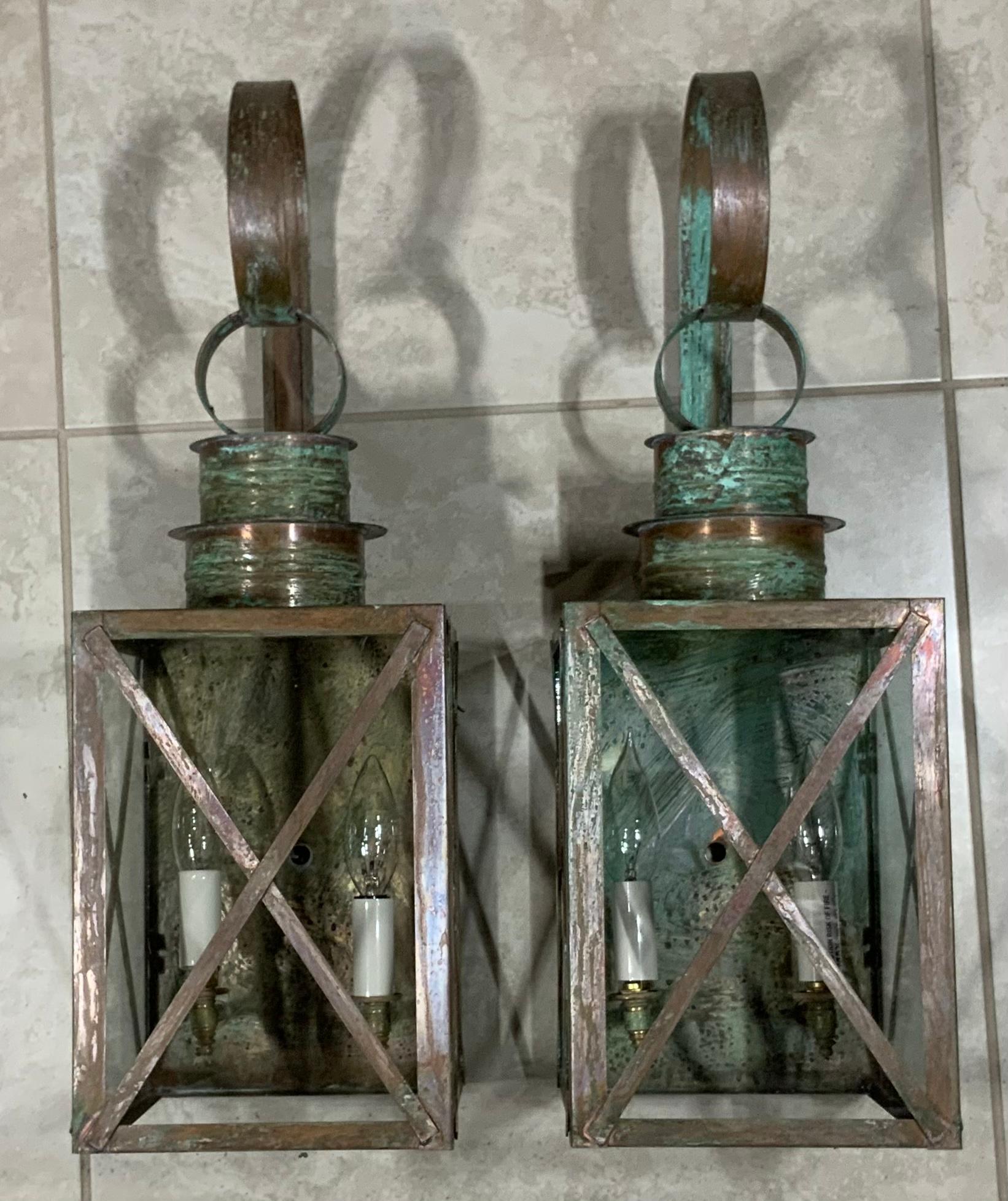 Elegant pair of lantern made of solid copper with protective X bars, weathered patina, electrified and ready to install,
Two 60/watt light on each lantern, up to US code UL approved, suitable for wet locations. Great patina. Will look good outdoors