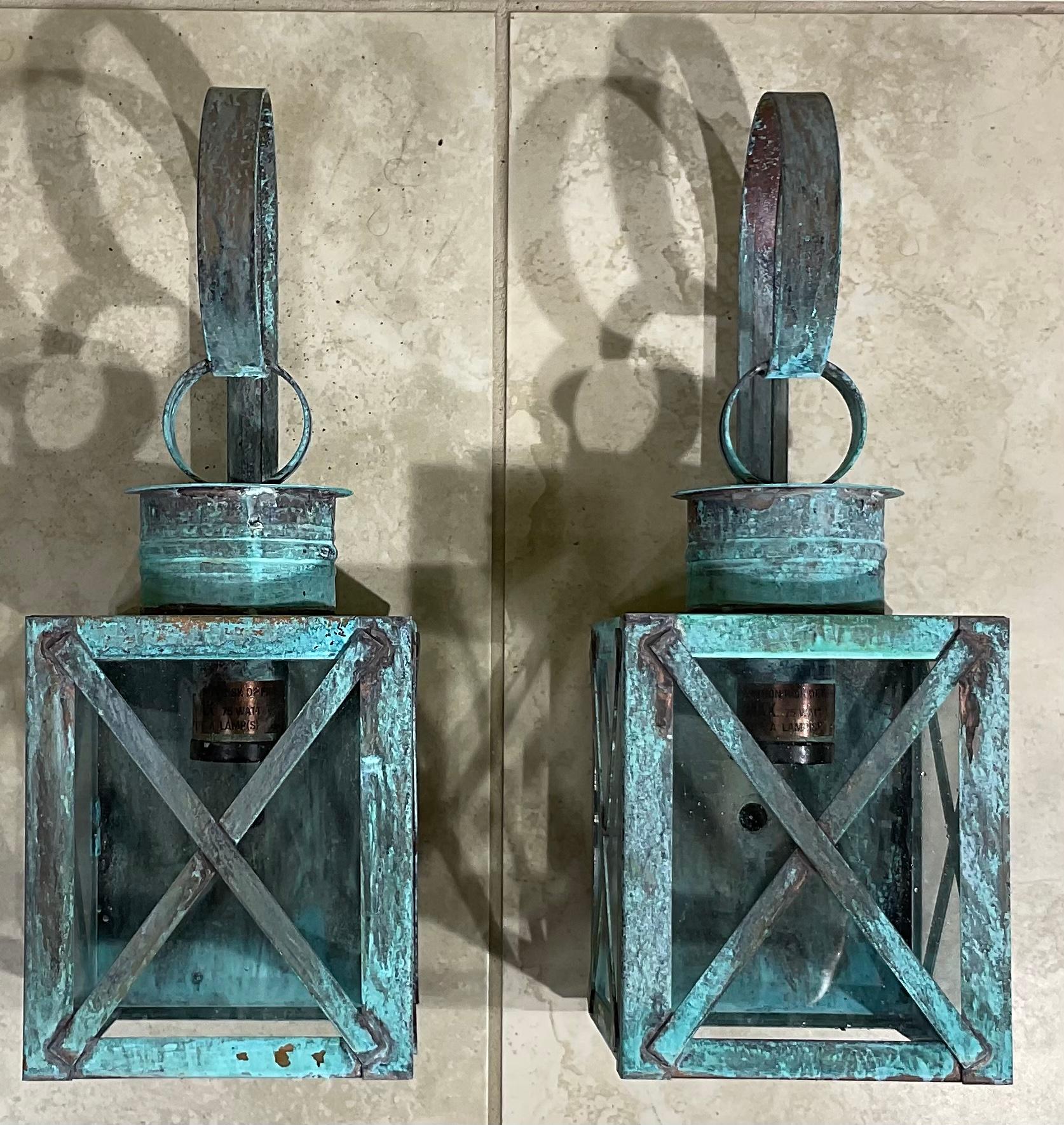 Pair of wall lantern made of solid copper, protective X bars, weathered patina, with one 75/watt light each. Suitable for wet locations. UL approved, up to US code, ready to use.
Fine quality, made in the USA.