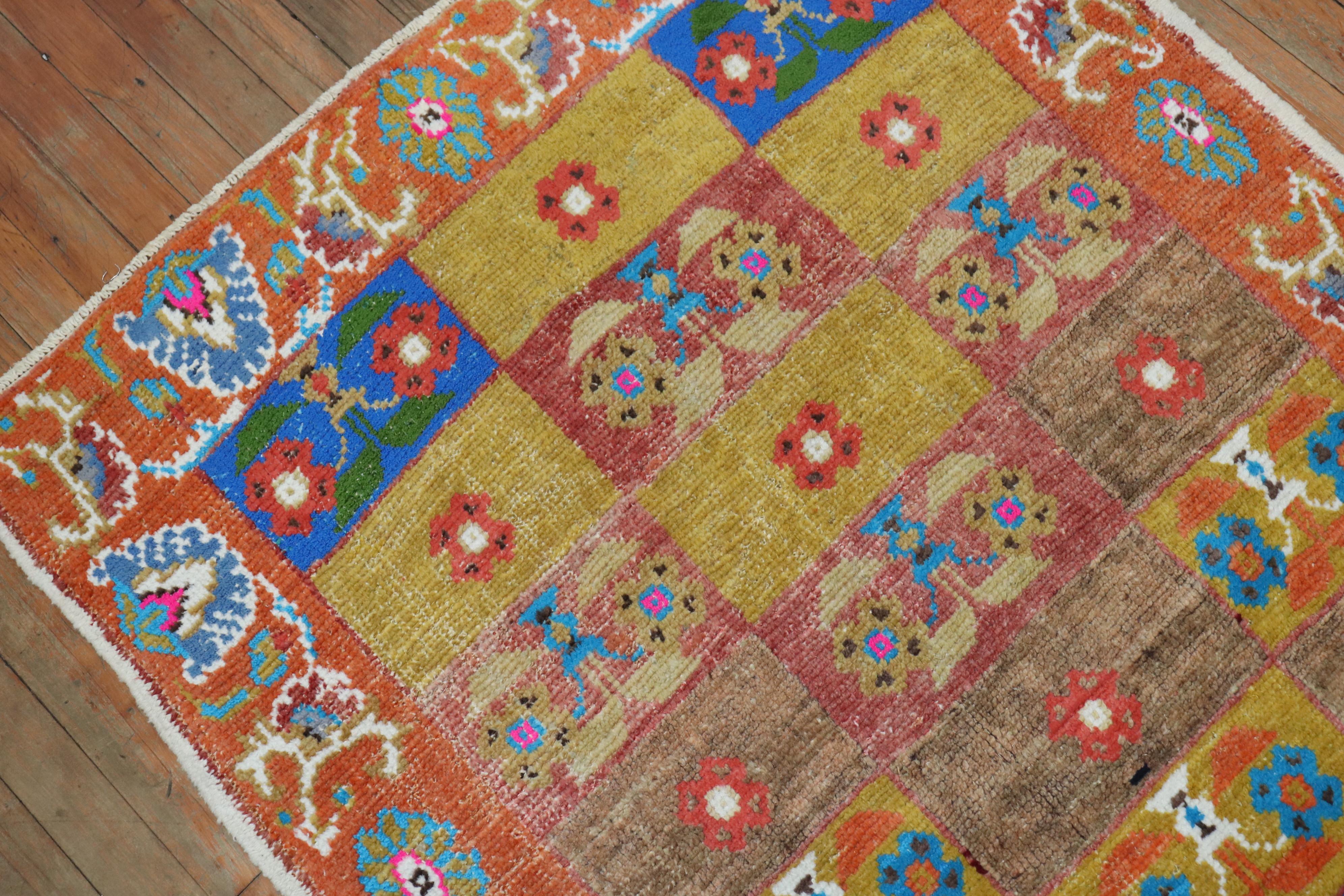 A pair of mid-20th century Turkish Anatolian rugs in bright intense colors. A multi-color repetitive box design surrounded by an orange peel border

Measuring: 3'2