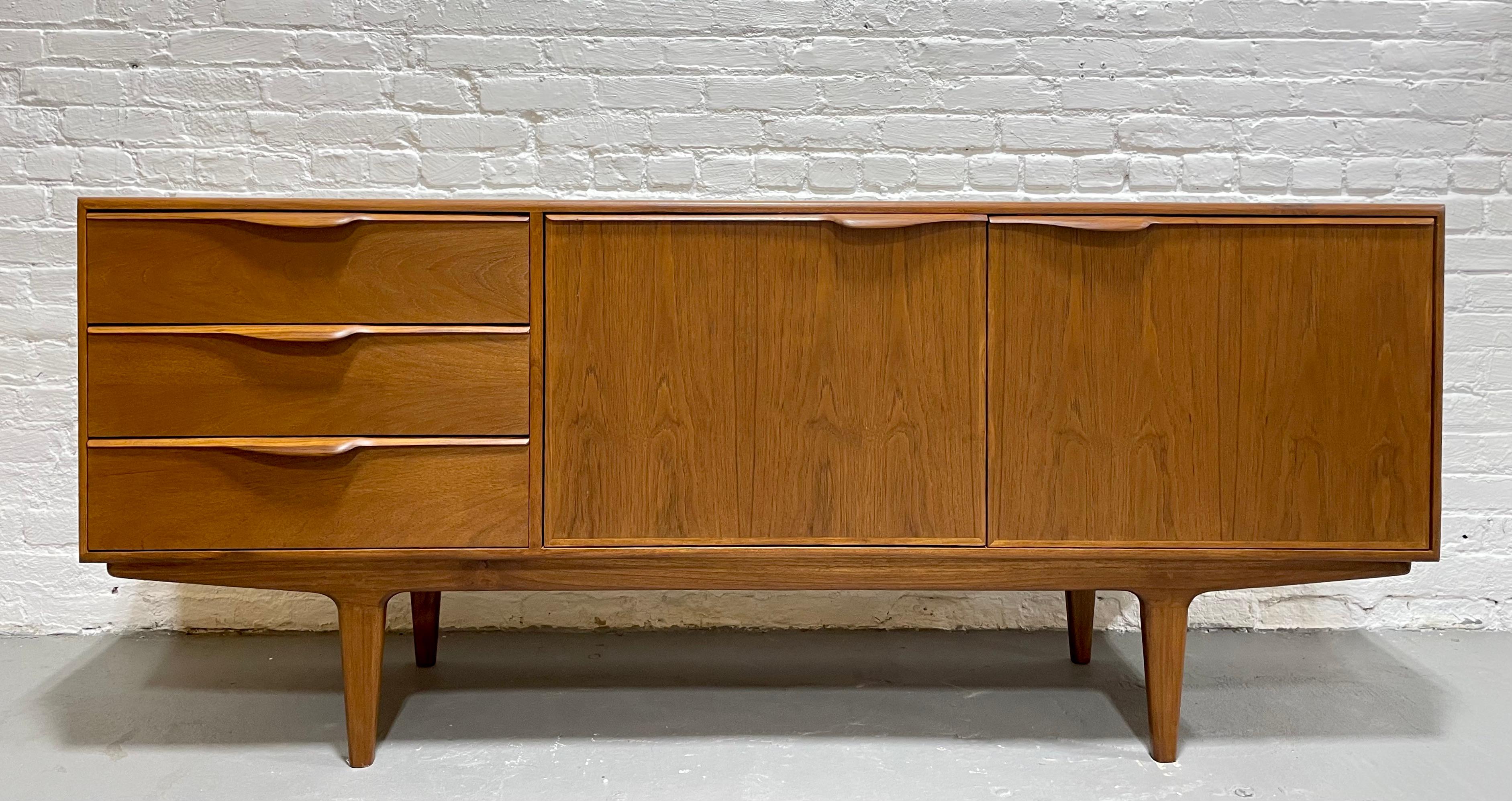 Sculptural + Funky Mid Century Modern styled Credenza / Media Stand with loads of storage space in the three deep + spacious drawers and two shelving areas, each with an adjustable/removable shelf. The handpulls are set asymmetrically on the drawers