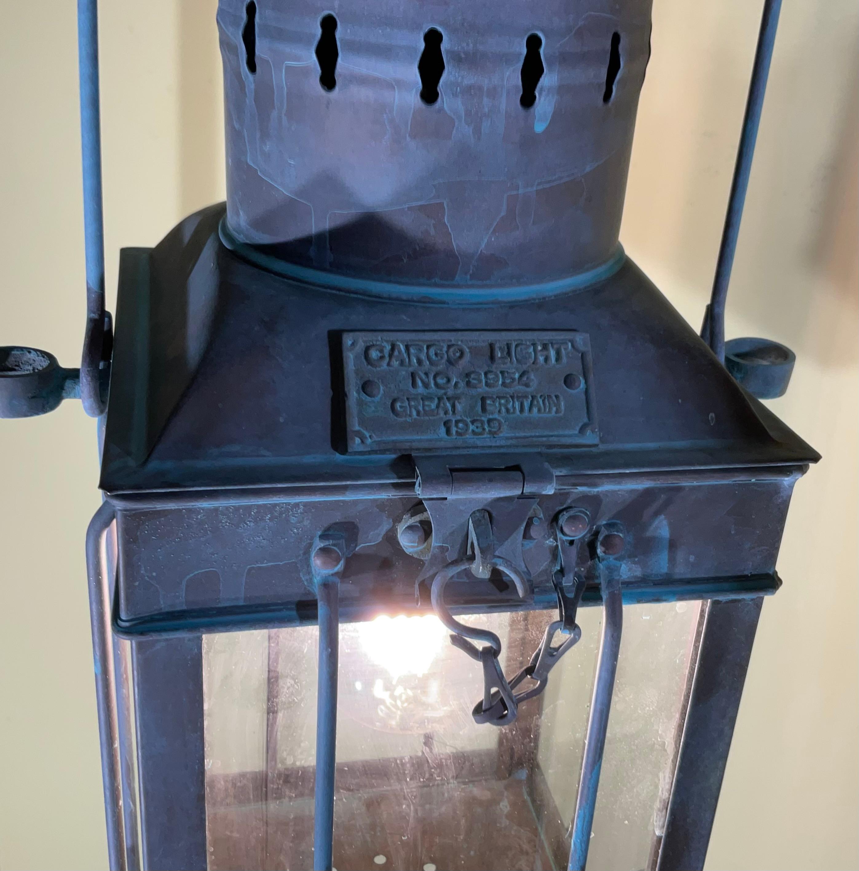 

Bring a piece of maritime history into your home with this authentic vintage cargo lantern from 1939, originally used on a British cargo ship., converted to be hanging lantern ,This unique light fixture has been professionally converted to