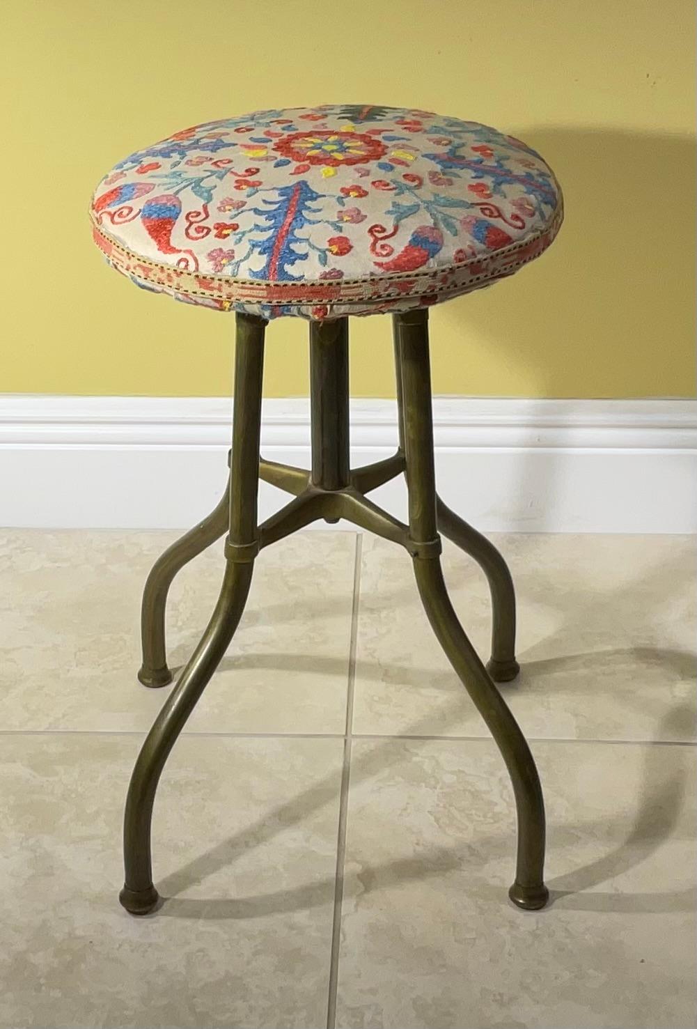 Exceptional vintage  swivel stool made of solid brass ,  upholster with beautiful hand embroidery vintage Suzani textile , silk embroidered flowers and vine with wine and turquoise colors, nice antique hand embroidery geometric suzani trimming
