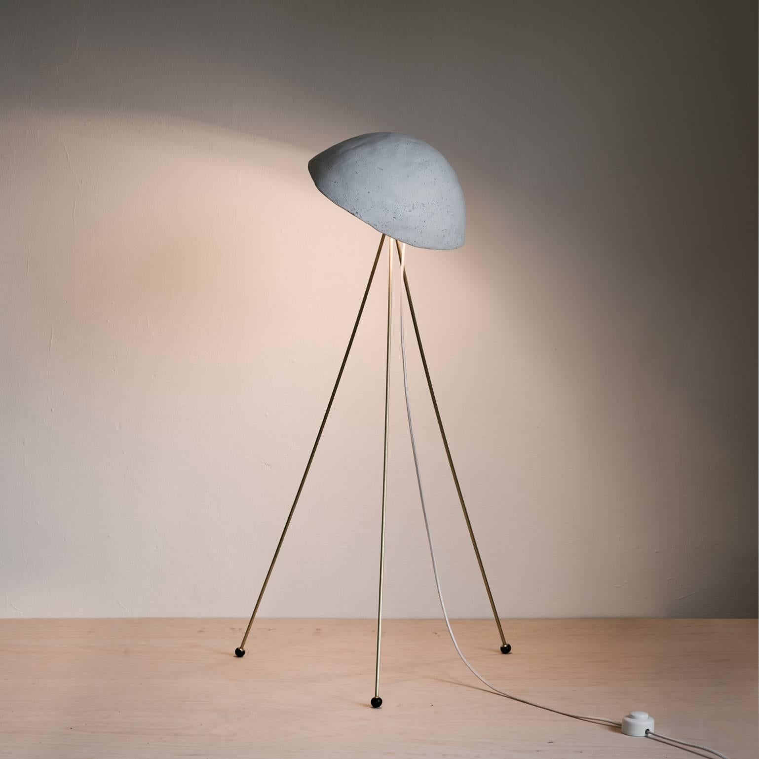 The Funny Buddy Floor Lamp has a hand-cast, irregularly domed gypsum 