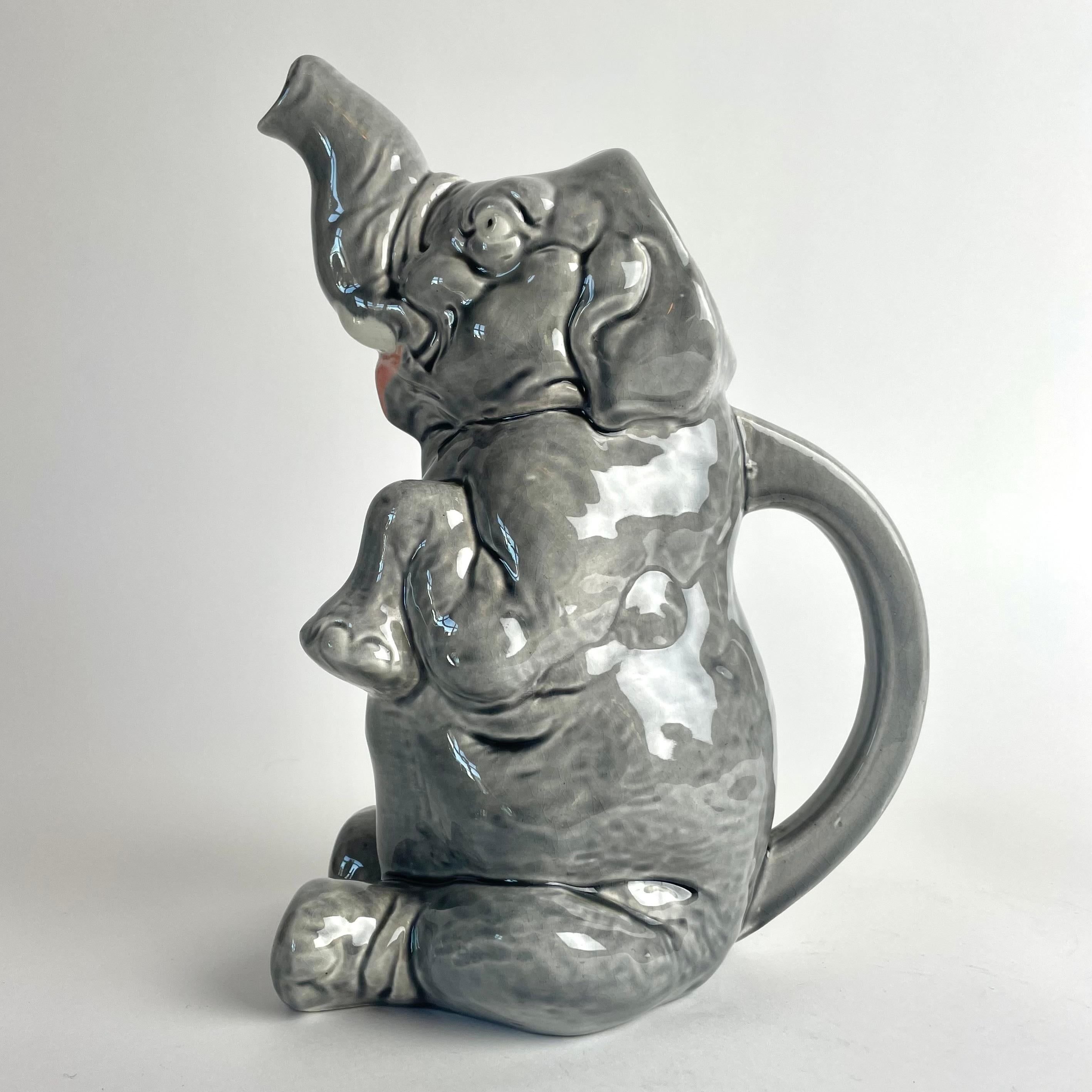 Very decorative and fun Majolica Pitcher in the shape of a sitting elephant by Sarreguemines from France. Probably made in the early 20th Century

Wear consistent with age and use 