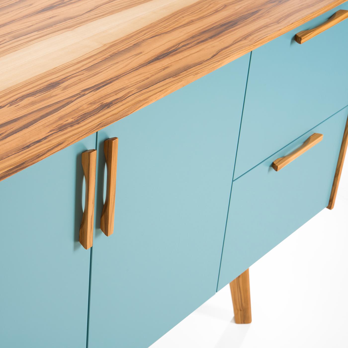 The Funny Sideboard centers around pure design wherein form follows function without compromising style. Impeccably handcrafted, the top features three storage compartments (two with doors and a two-drawer unit) with flush-style veneered panels in