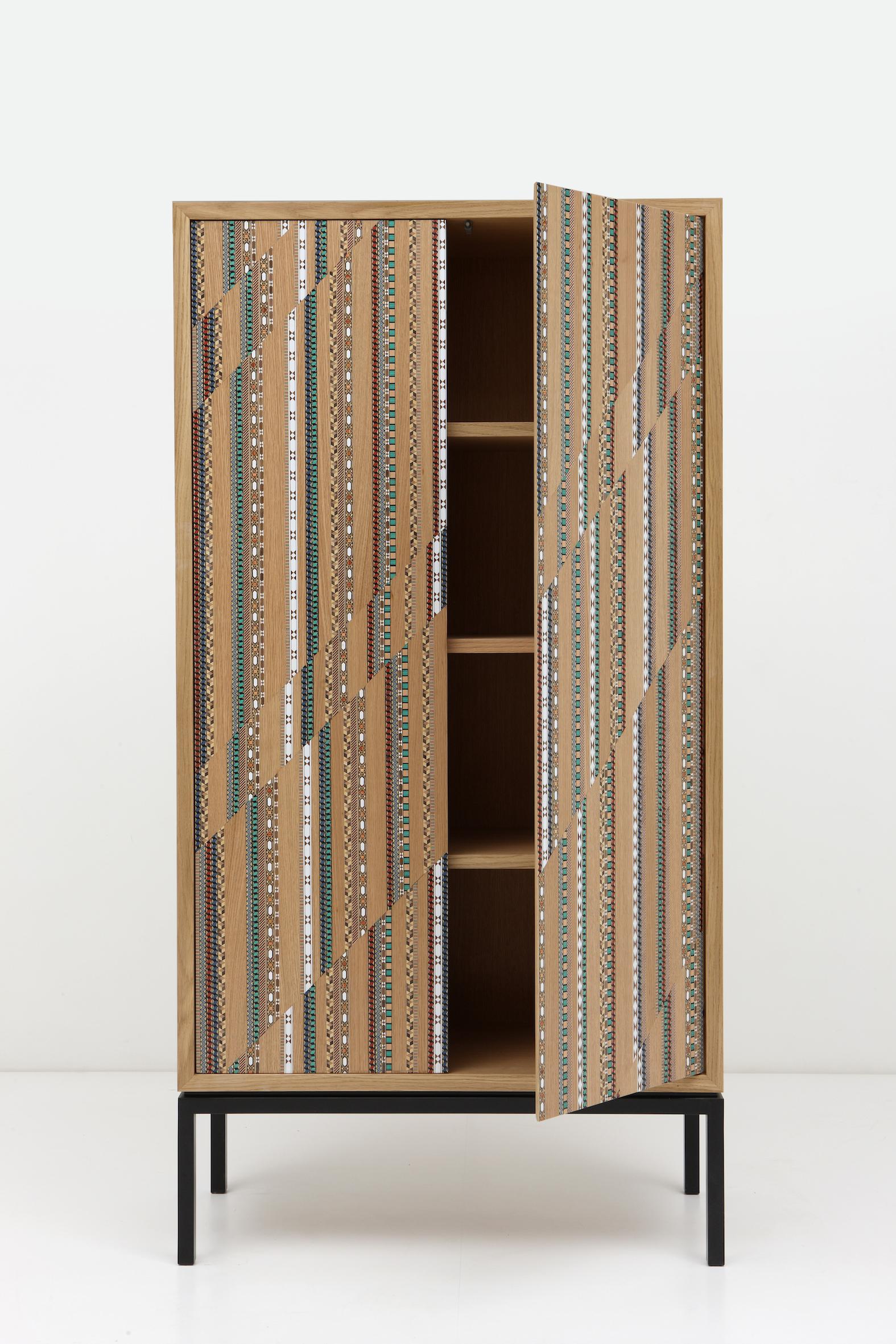 Part of the Funquetry collection, the shift cabinet creates a graphic interpretation of the traditional craft of wood marquetry. By creating a shift, the colorful patterns are accentuated.