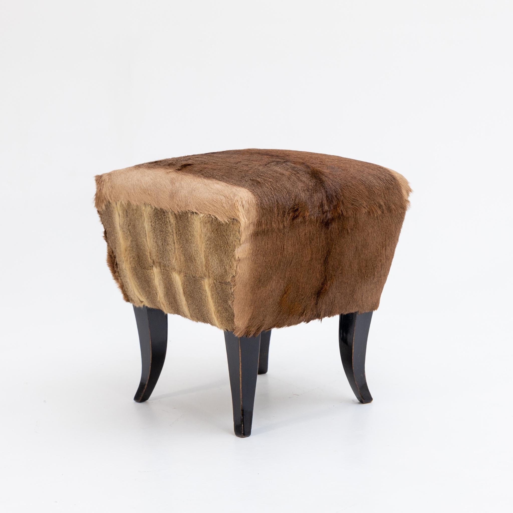 Small fur stool on ebonized wooden frame with brown rabbit fur cover, newly reupholstered.