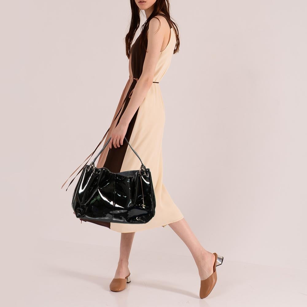 Furla's hobo is a spacious bag with a lovely design. This here is crafted using black patent leather and styled with a single handle and a fabric-lined interior.

Includes: Original Dustbag, Info Booklet
