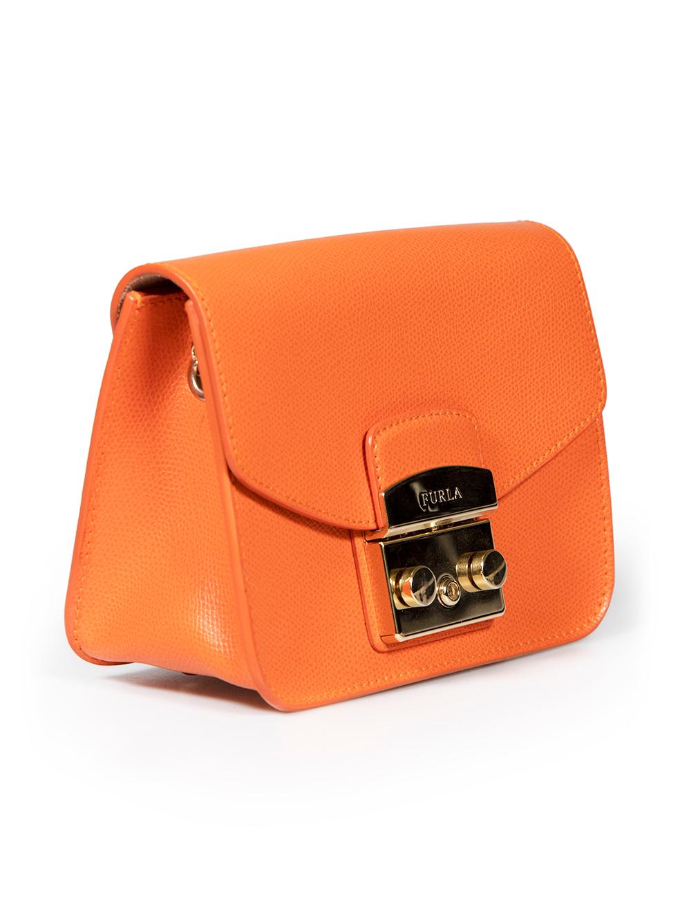 CONDITION is Very good. Minimal wear to bag is evident. Minimal wear to metal hardware closure and base feet with some slight tarnishing on this used Furla designer resale item.
 
 
 
 Details
 
 
 Model: Metropolis
 
 Orange
 
 Leather
 
 Mini
