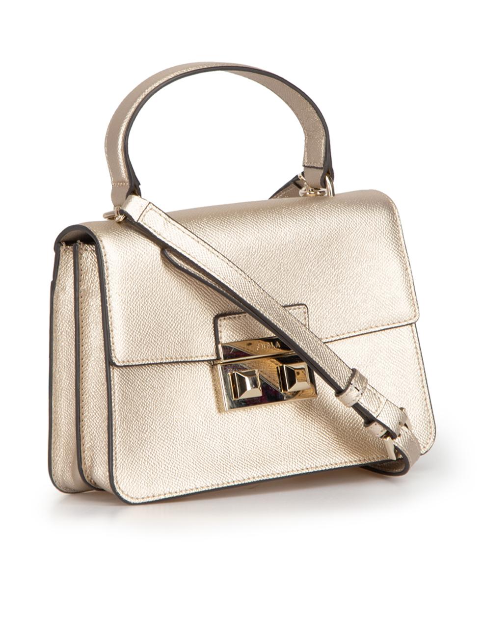 CONDITION is Very good. Hardly any visible wear to bag is evident on this used Furla designer resale item. This bag comes with original dust bag.



Details


Beige metallic

Leather

Small top handle bag

Gold tone hardware

1x Top handle

1x
