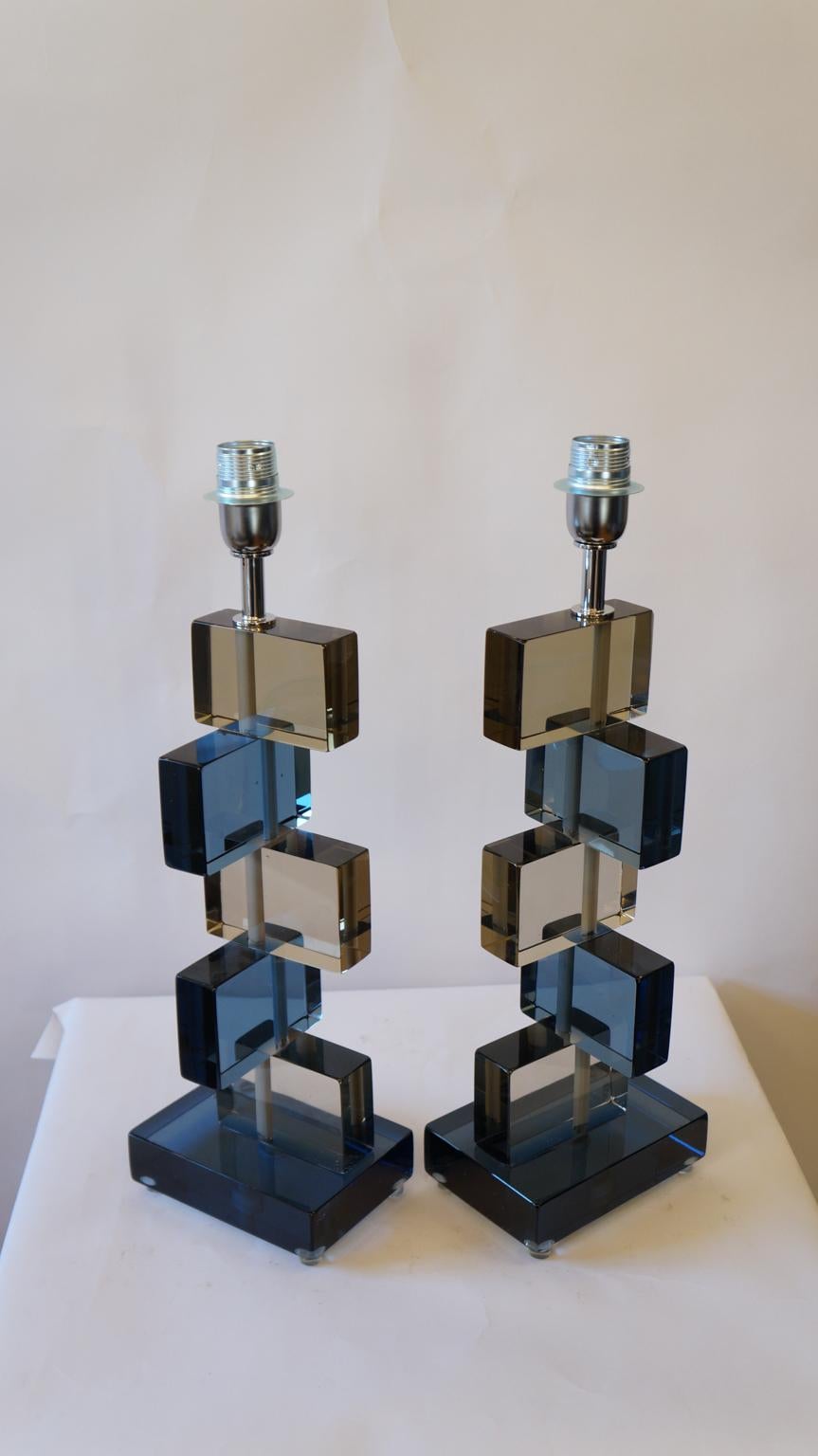 Two murano glass table lamps by Alberto Donà in 1975. 
In it we can see simplicity, elegance, linearity. It is, in fact, a simple model, and it is thanks to its colors that its beauty stands out. 
We note in fact the combination of blue and smoky,