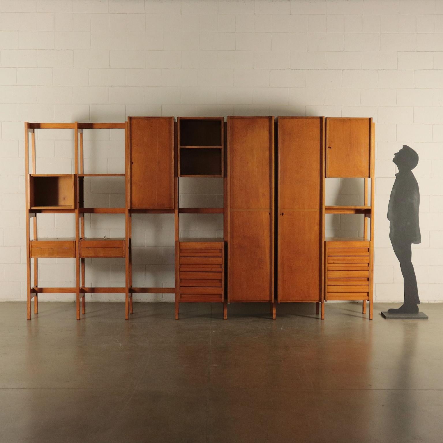 Wardrobe/bookcase. Only example projected by Mario Vender for a private commission of a house in Brianza. It is made with drawers and open compartments, two coat hangers and two containers that can be opened to create a writing surface. Beech