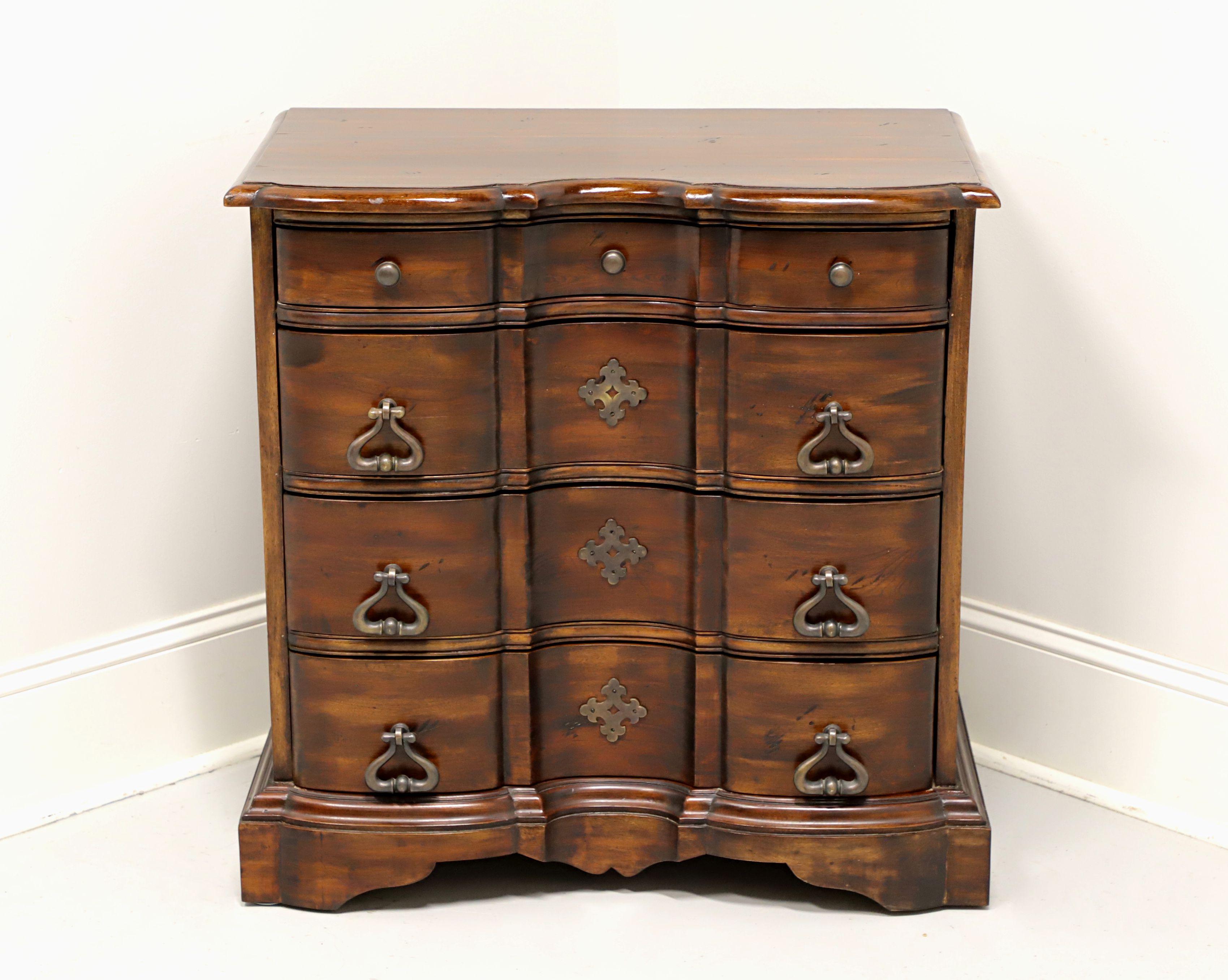 A Chippendale style bedside chest by Furniture Classics, of Norfolk, Virginia, USA. Mahogany with slightly distressed finish, brass hardware, serpentine shape, carved apron and bracket feet. Features four dovetail drawers with decorative brass