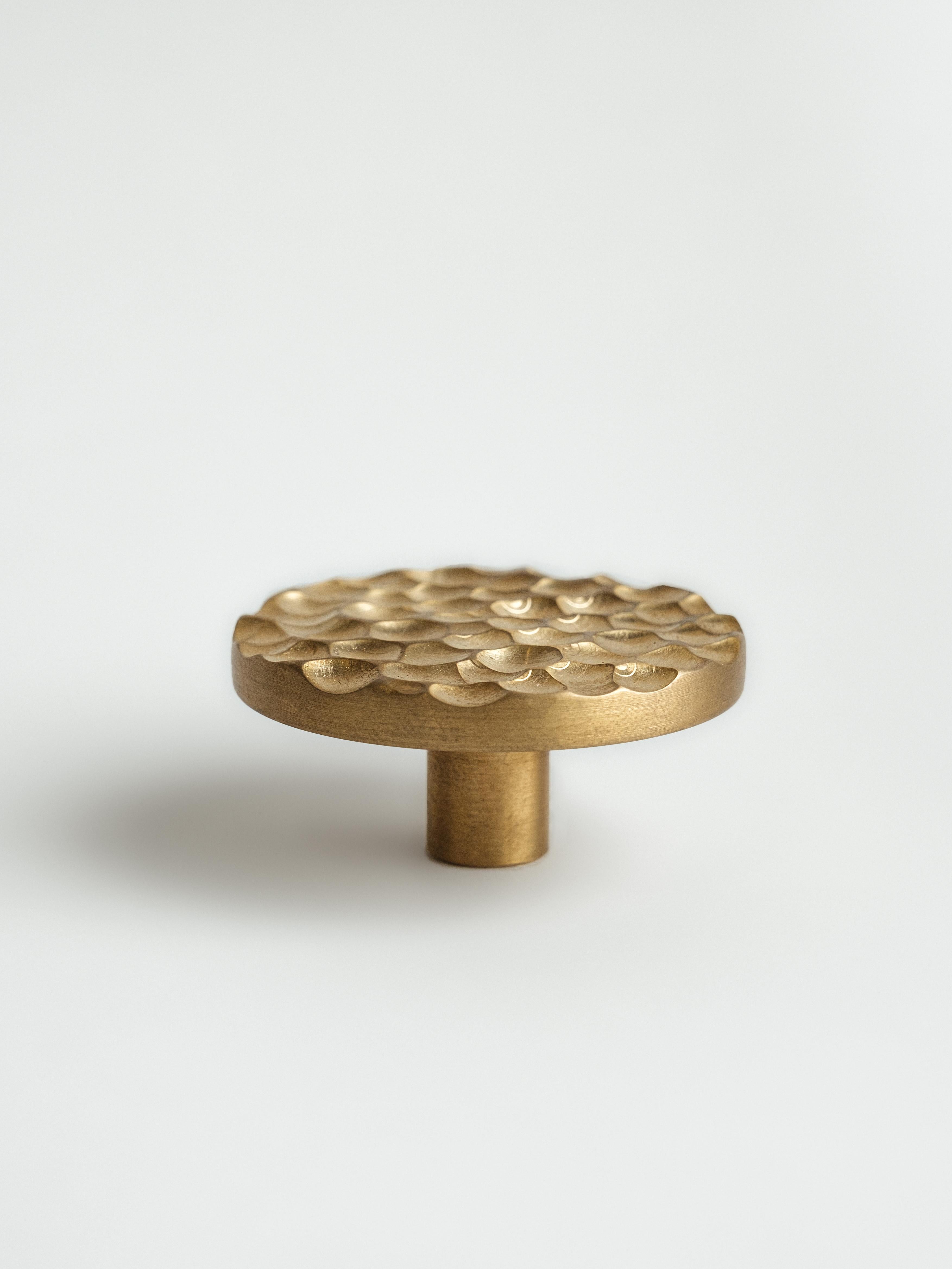 Handcrafted hardware by RUDA Studio is aimed to embody a touch of natural phenomena. The hammered brass handle reminds of honeycombs or drops of water frozen in the metal. This aesthetic and timeless detail will become a jewel for the