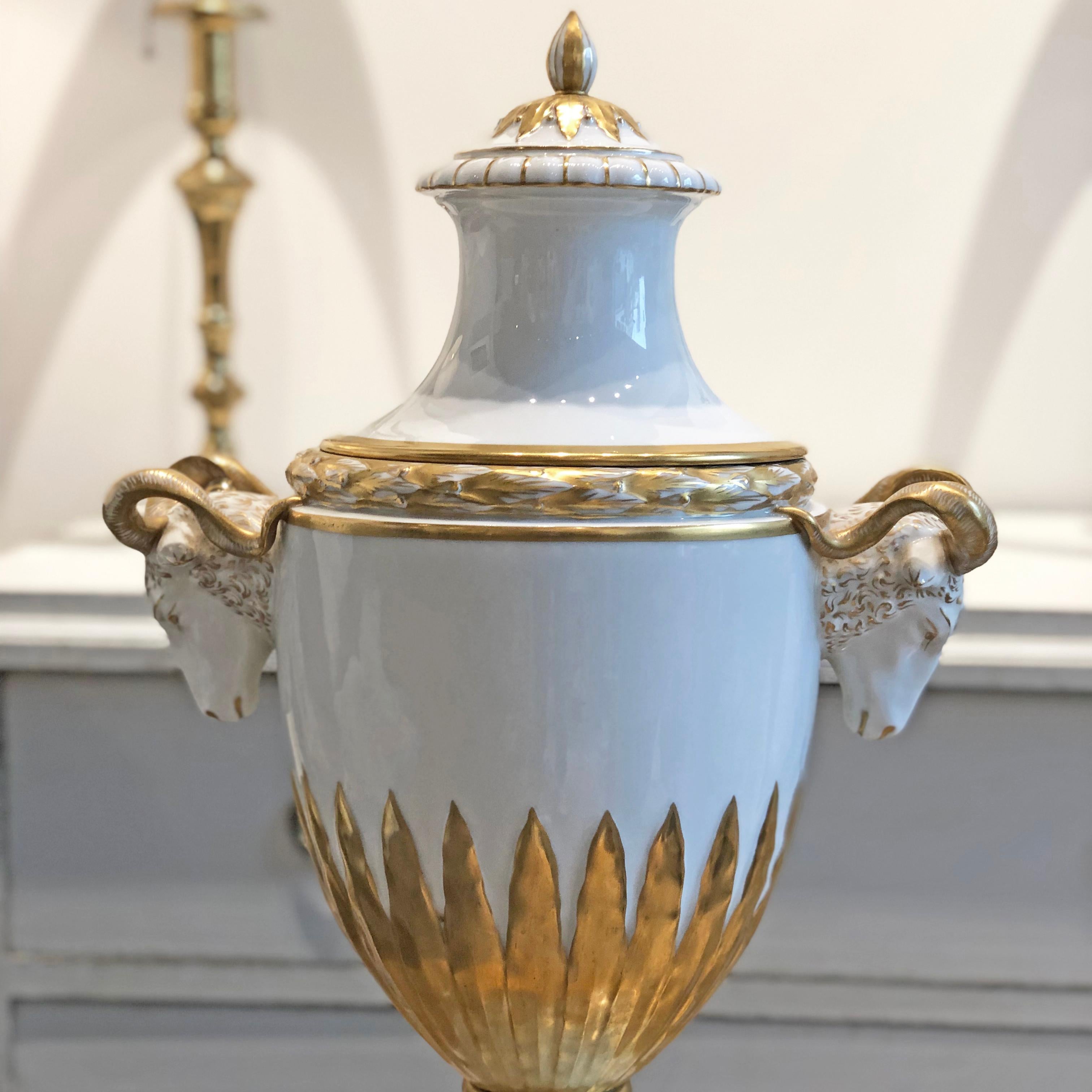 Furstenberg Porcelain Amphora vase from early 1900s with highly decorative ram’s head handles and lid. Made in Germany.

Measures: 36 W x 20 D x 56 H cm

Good antique condition considering the age.