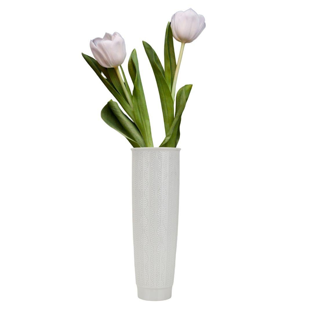 A very stylish round glossy glazed white porcelain vase by Fürstenberg with a floral organic leaf relief pattern, a real beautiful and elegant piece of decorative art. This vase is crafted by Fürstenberg, a renowned German porcelain manufacturer