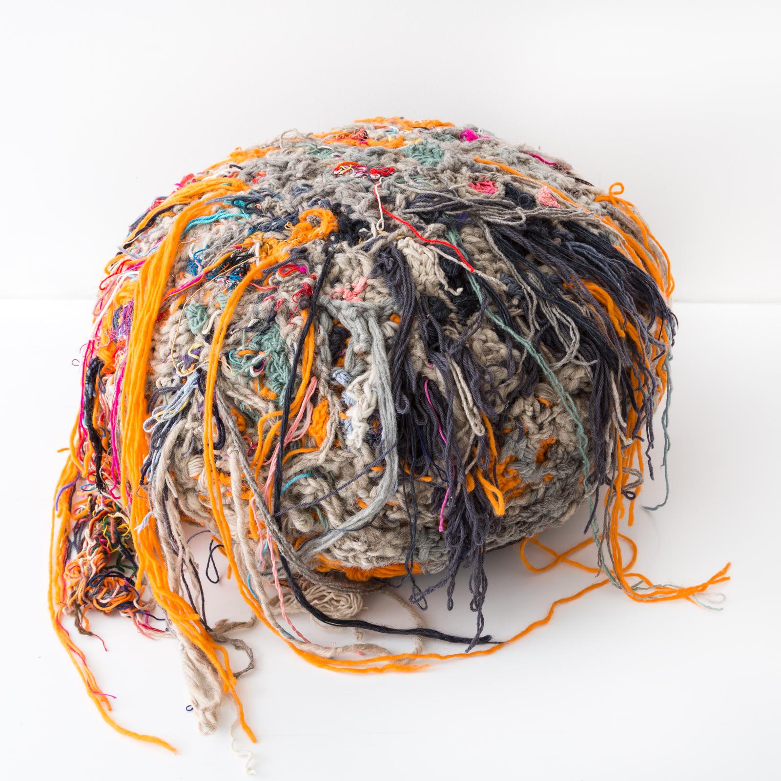 Further Forms are a grouping of bright and hairy ottomans that have creature-like qualities. Tamika Rivera sculpts the Forms by wrapping, knitting and knotting yarn and string onto stuffed geometric forms. She builds off these forms to create this