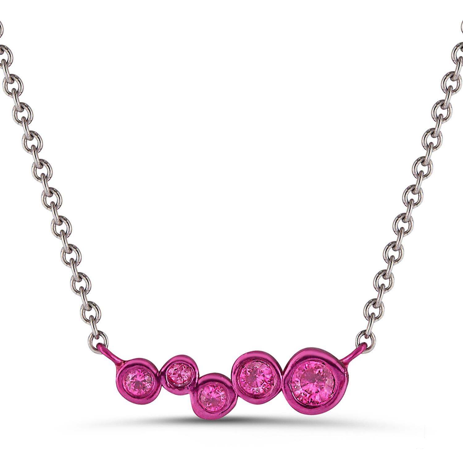 Hi June Parker's version of the classic bar pendant sprinkled with tapering sizes of Rubies ceramic plated with Fuschia pink to add a pop of electric color to your neck.

Inspired by seeing the cross-section view of life, as if slicing a tree to see