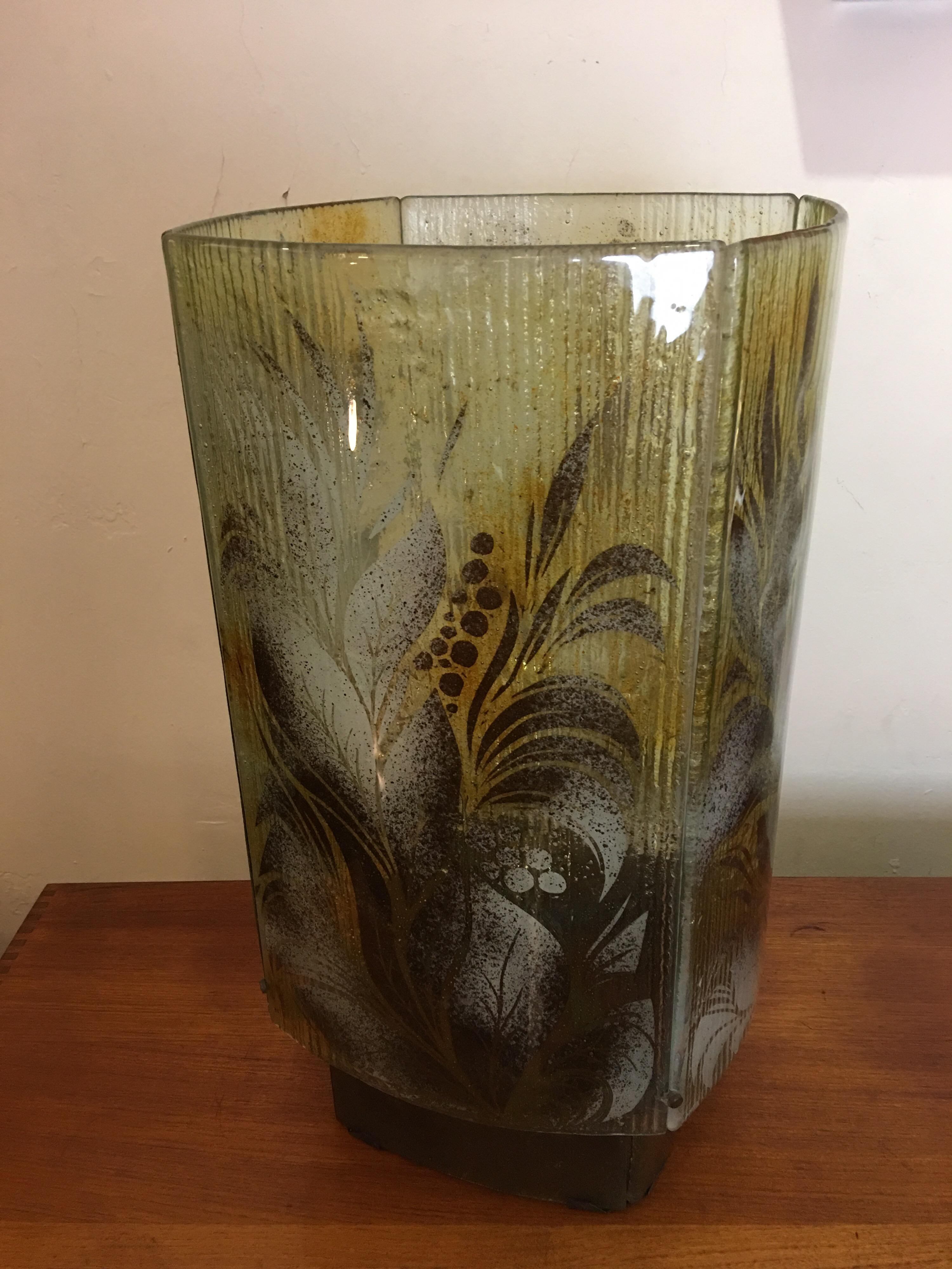 Fused or slumped glass table lamp. Made up of 4 slightly curved pieces of glass. Each panel has a leafy design motif. Base is also 4 pieces of glass. Technique is similar to Frances and Michael Higgins, American glass workers who specialized in