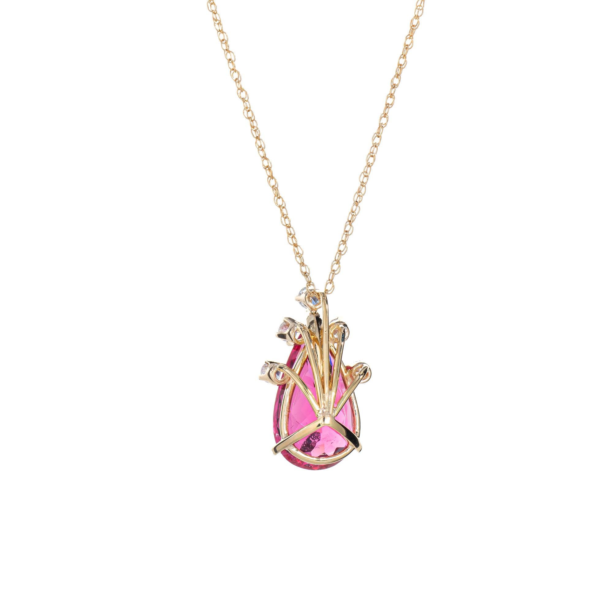 Stylish and finely detailed fushia pink tourmaline & diamond pendant + necklace crafted in 18 karat yellow gold (pendant) and 14k yellow gold (chain).

The pink tourmaline measures 17.0 x 9.4 x 7.3mm (estimated at 7.20 carats). The tourmaline is a