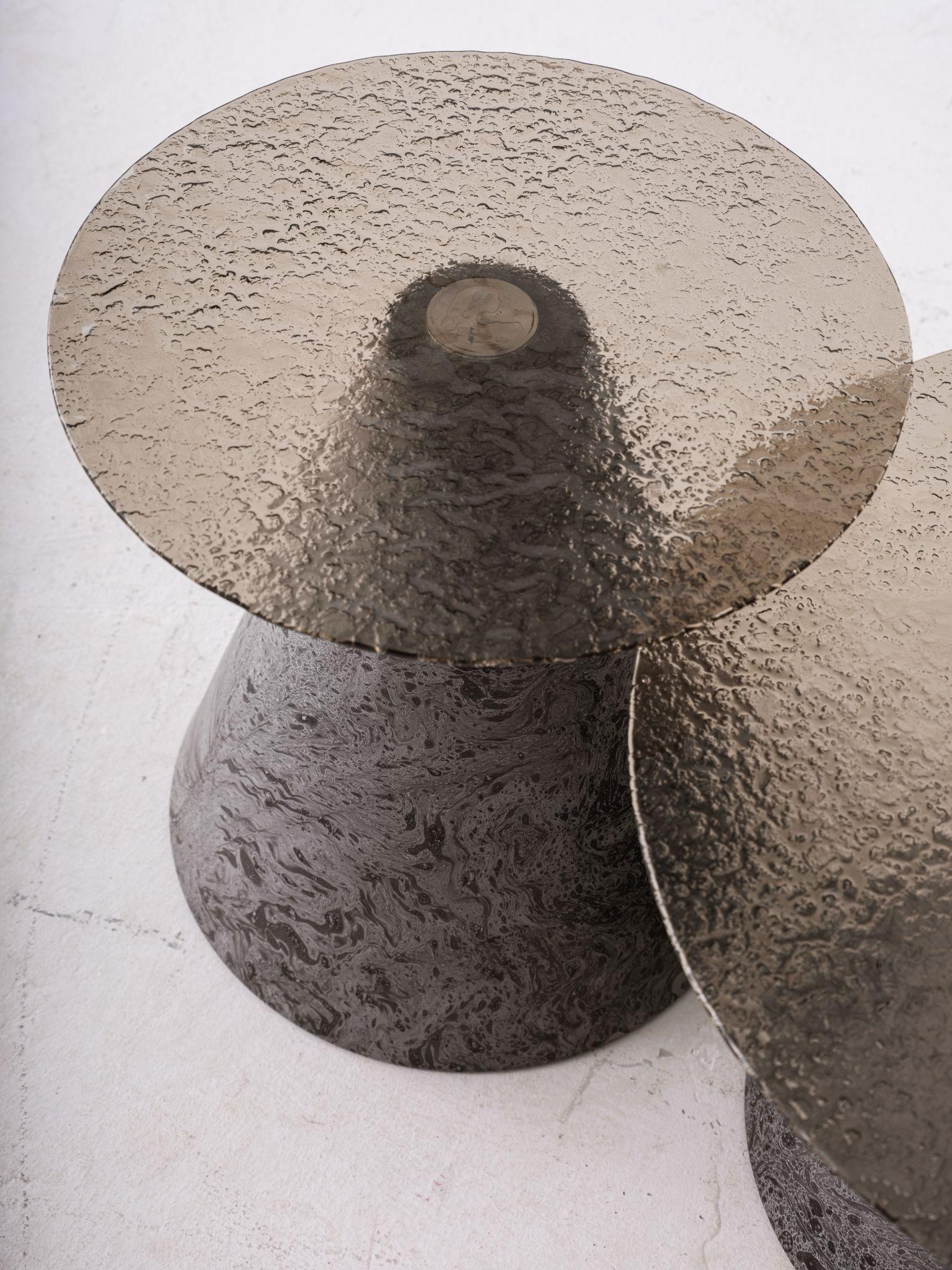 A refined blend of artistry and function — this Fusion Glass Side Table features a beautifully textured smoked glass top, bringing a sense of depth and elegance to your interior.

The conical base is crafted with a dynamic marble-effect surface,